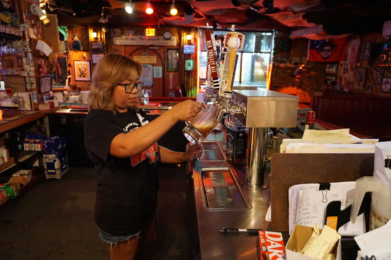 Lourdes Montemayor pours a beer you can only get at Godfather's Bar—the "smooth and strong" Red Trolley Ale​​.