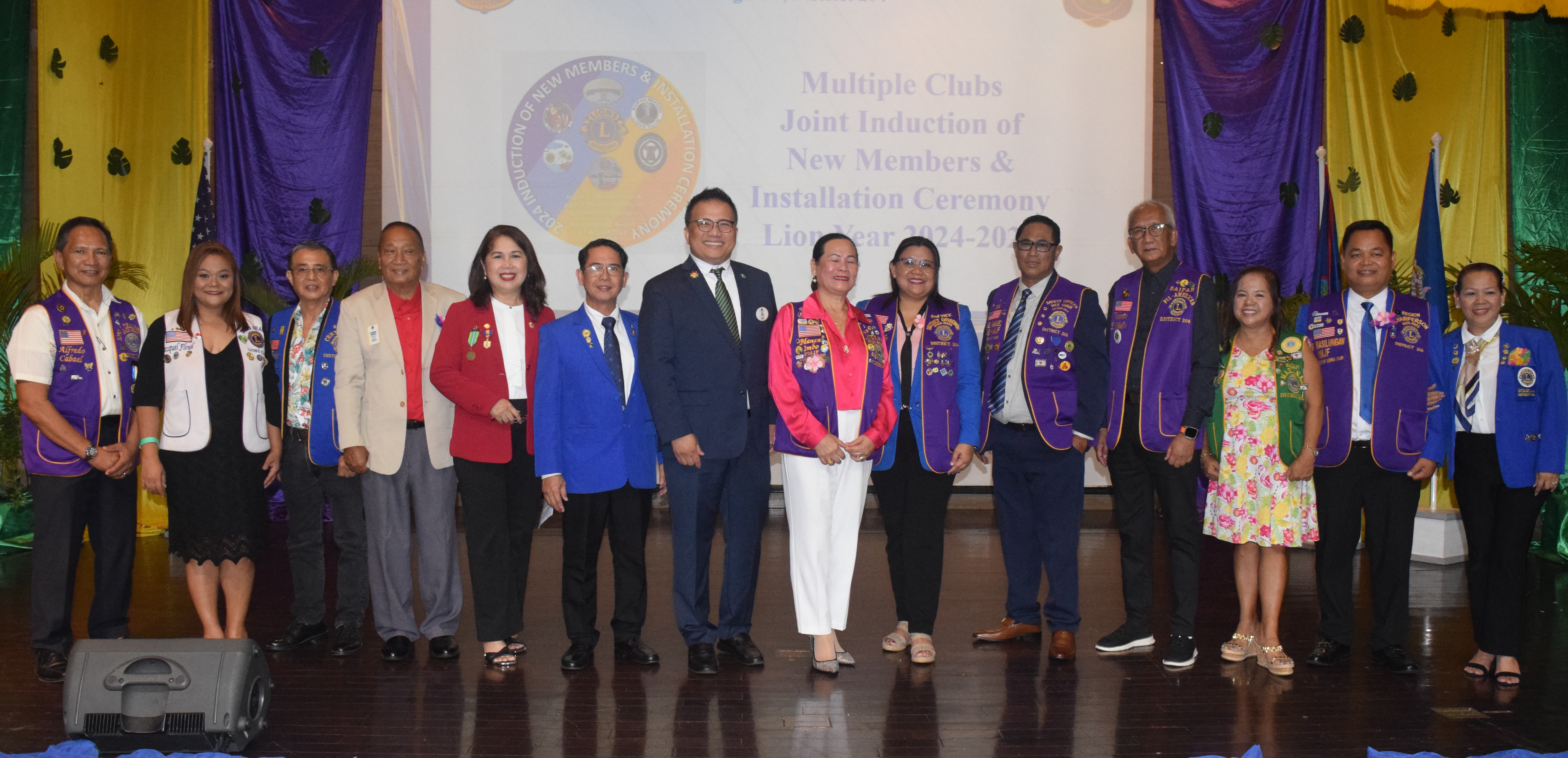 Lions Club International District Governor Lion Roy Adonay, seventh, left, First Vice District Governor Ronaldo Hidalgo, sixth left, Global Membership Team Coordinator Loisa Cabuhat, fifth left, Immediate Past District Governor Bianca Imbo, center, and Region 2 Chair Marcelo Masilungan pose for a photo with the new club presidents of Lions Clubs International District 204 at the Saipan World Resort's Royal Taga Hall on Saturday.