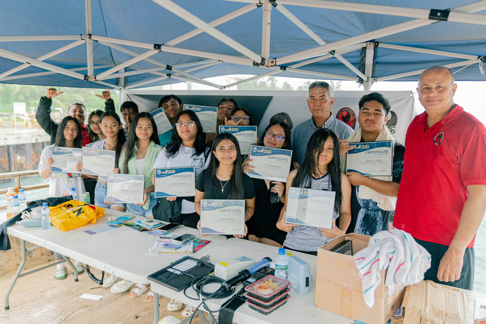 Students gather for a group photo alongside Aquaculture and Natural Resources Acting Program Leader Jerry Barcinas, Research Assistant Kimo Lizama, and BECQ-DCRM representative William Pendergrass after completing Rota’s inaugural Aquaculture Summer Youth Academy.
