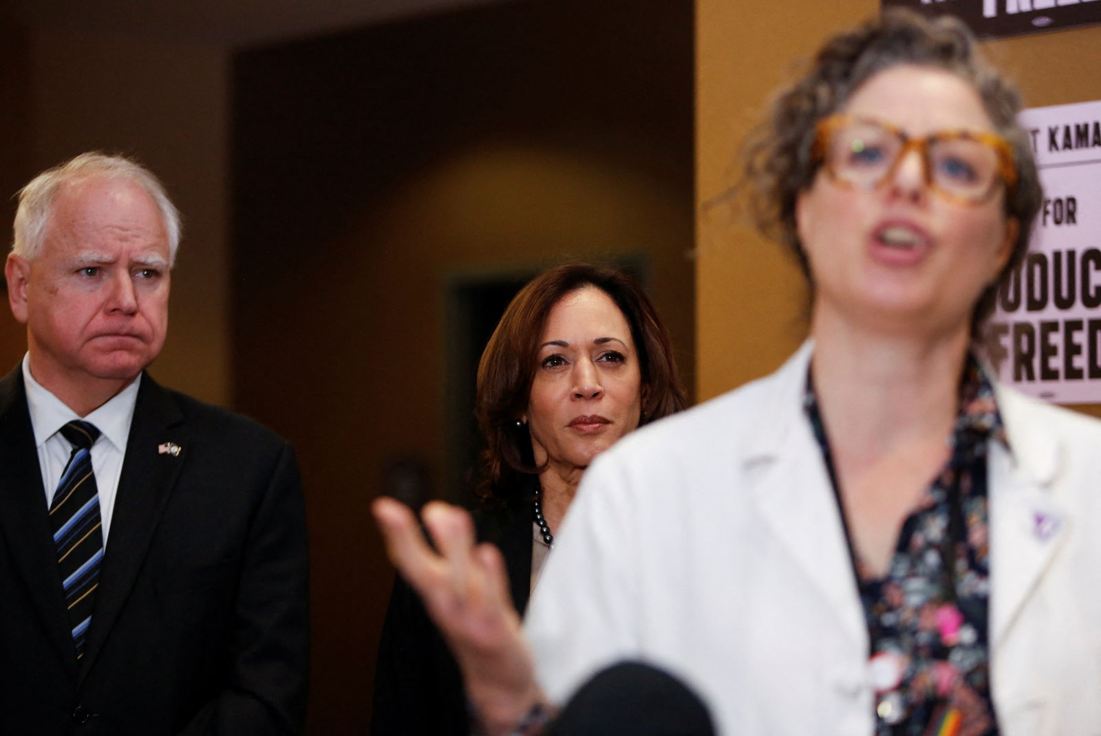 Vice President Kamala Harris and Minnesota Governor Tim Walz listen to Dr. Sarah Traxler as Harris visits the St. Paul Health Center, a clinic that performs abortions, in St. Paul, Minnesota, March 14, 2024.