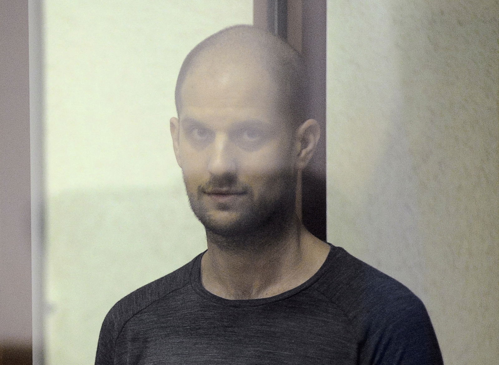 Wall Street Journal reporter Evan Gershkovich, who faces charges of espionage, stands inside an enclosure for defendants as he attends a court hearing in Yekaterinburg, Russia, July 19, 2024.