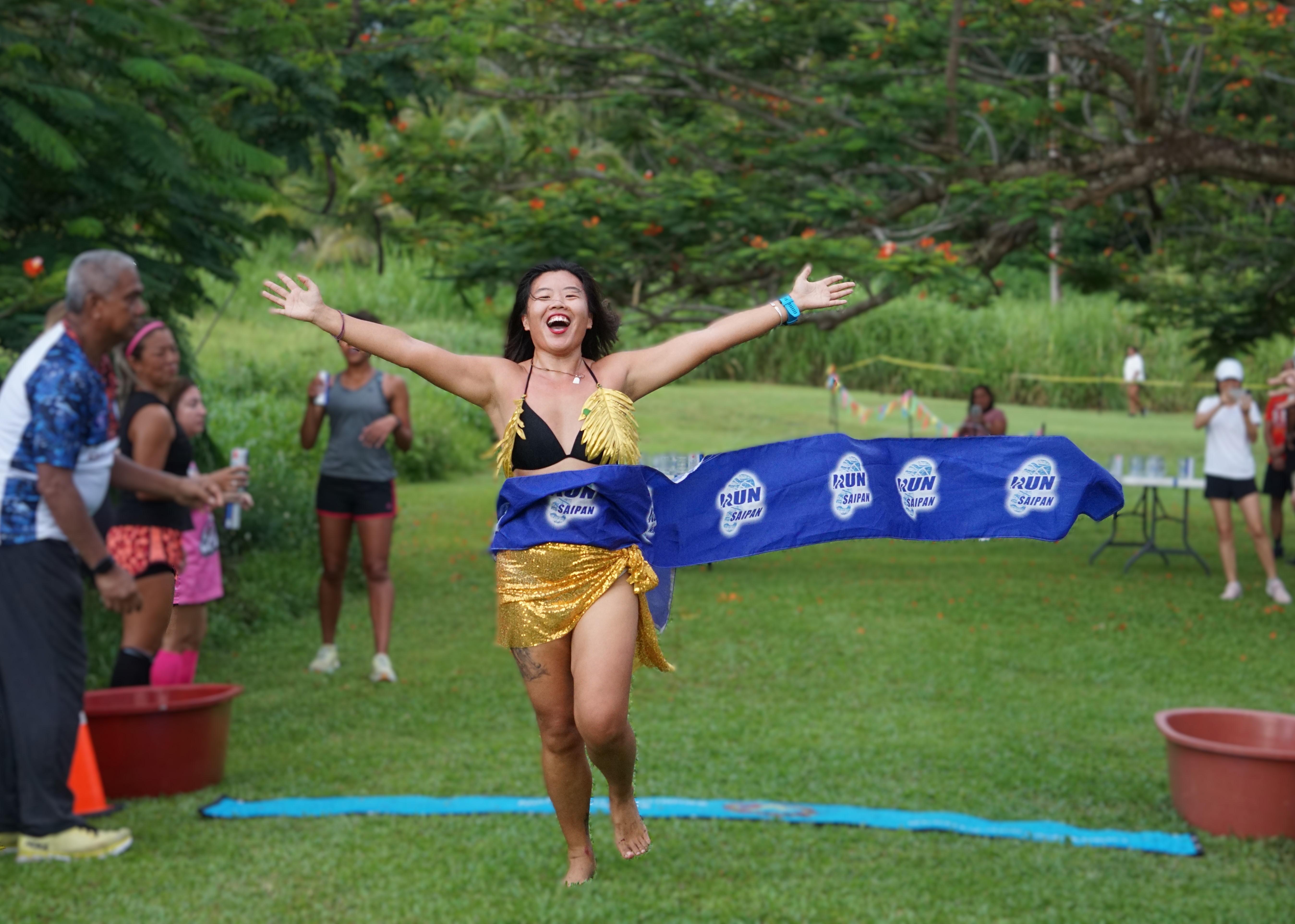 Madge Gai celebrates as she finishes first in the women's division of the 3rd Annual Michelob Ultra Beer Mile 2024 the Saipan Vegas Country Club on Friday.