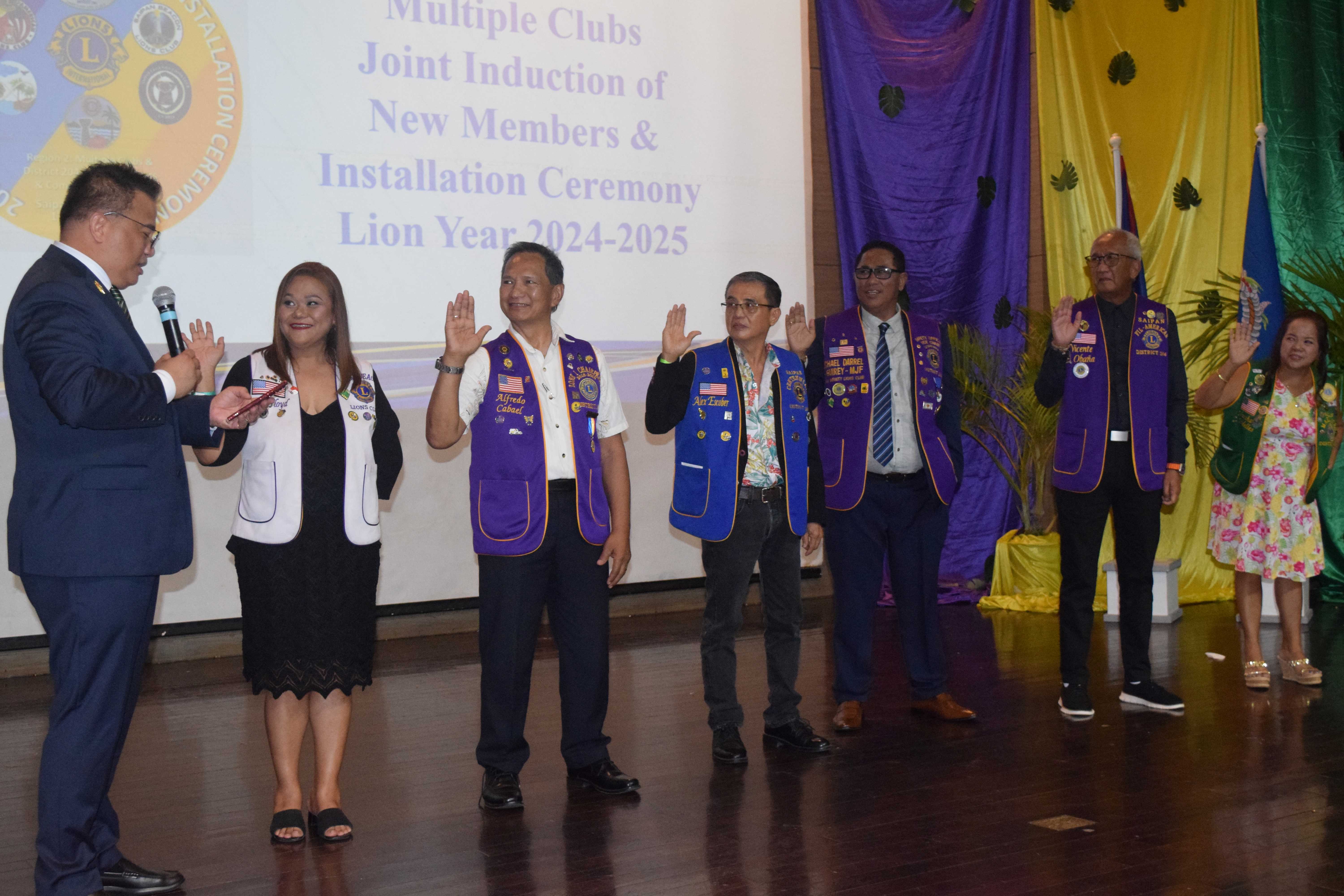 Lions Clubs International District Governor Roy Adonay, left, swears in Saipan Beacon Lions Club President Raquel Floyd, Saipan Legends Lions Club President Alfredo Cabael, Saipan Centennial Lions Club President Alexander Escober, Saipan Infinity Lions Club President Michael Guirey, Saipan Fil-American Lions Club President Vicente Obana, and Saipan Marianas Lions Club President Martha Badilles during an induction and installation ceremony at the Saipan World Resort's Royal Taga Hall on Saturday.