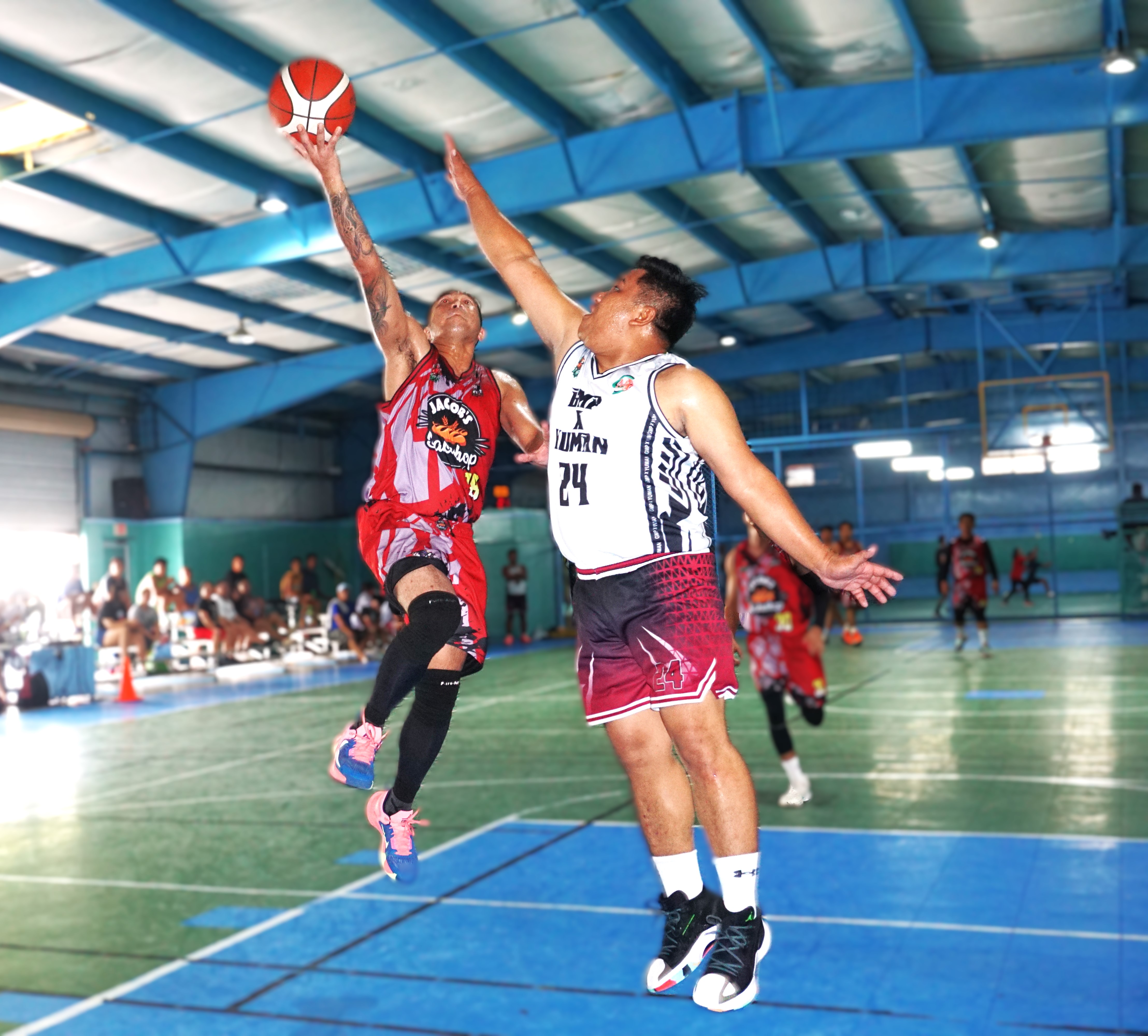 Jacob's Bakeshop's Jerome Reyes extends for the finish over a defender during a game against GMP x Yuman in the Destroyers Basketball Club Invitational Basketball League 2024 at the TSL Sports Complex.