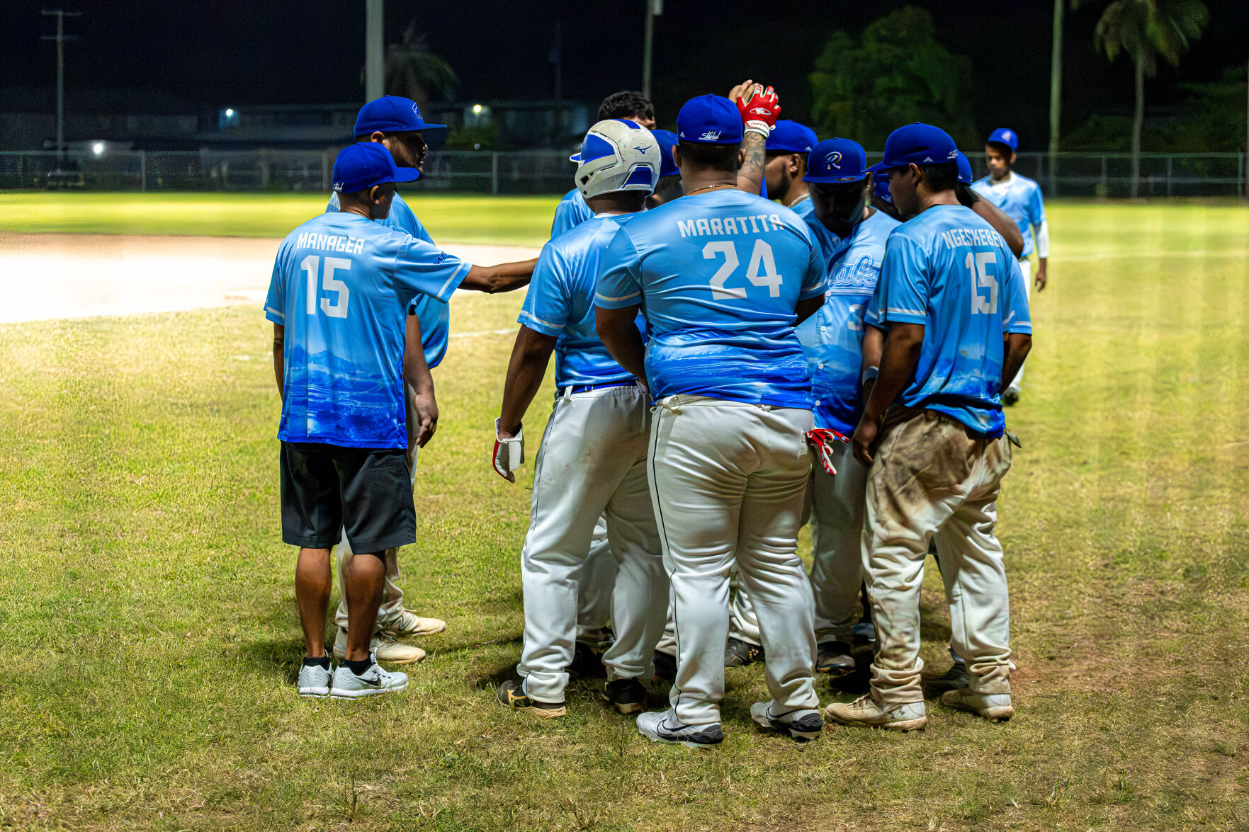 The Royals gather for a quick huddle before returning to the field during a game in the 2024 Tan Holdings Saipan Baseball League at the Francisco "Tan Ko" Palacios baseball field.