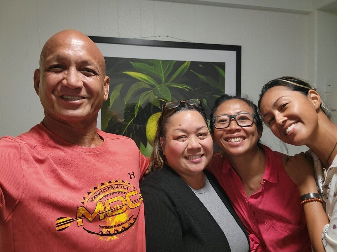 Pat Mae Villanueva, a former San Antonio, Saipan resident, poses for a photo with the CNMI’s paddlers after bringing food, water and snacks for the team.