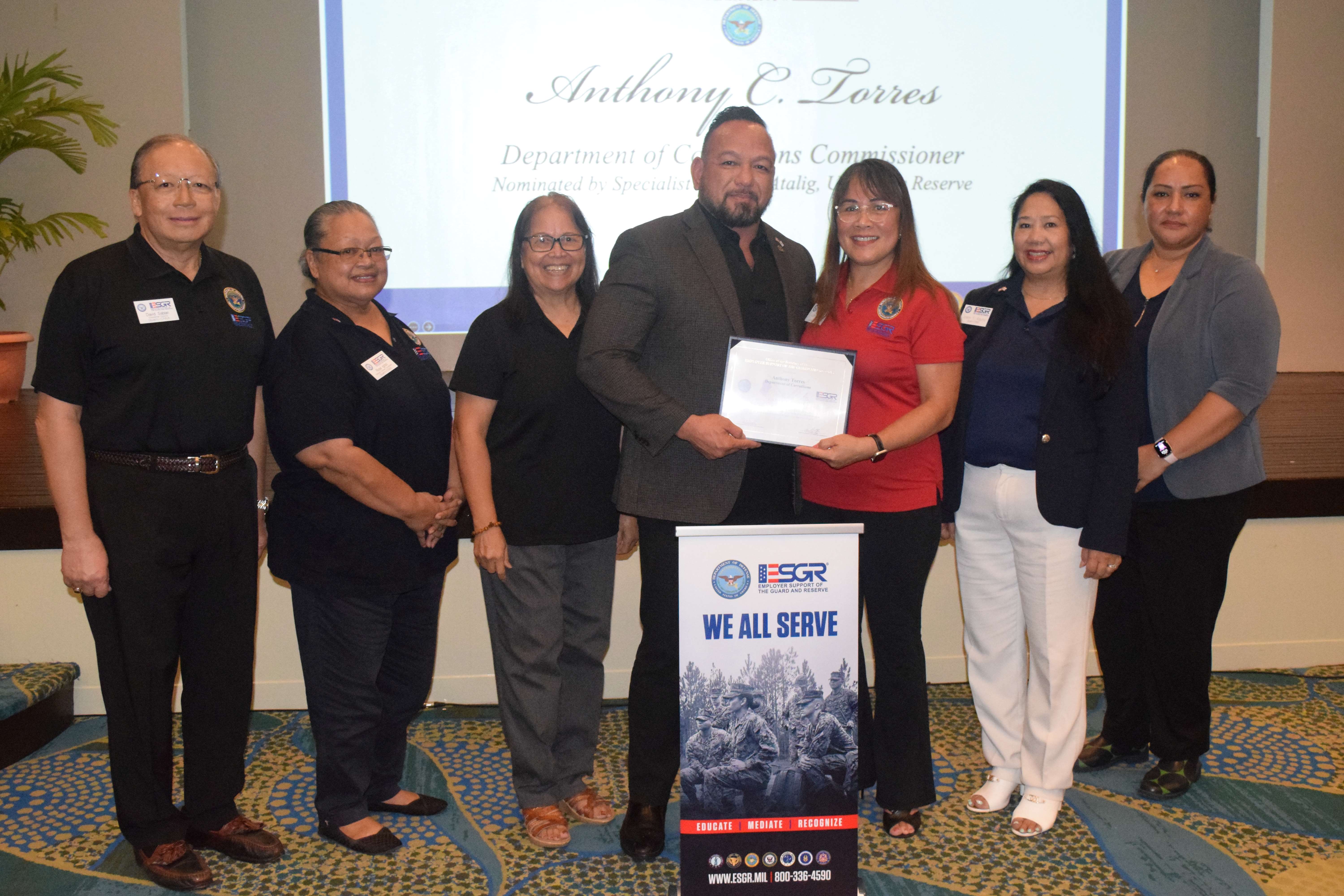 Department of Corrections Commissioner Anthony C. Torres, center, receives the Patriot Award from ESGR Guam-CNMI State Chair Cathy Gogue. Also in photo are Ombudsman Director Dave Sablan Jr., Employer Outreach Coordinator Rose Igitol, Area Chair Dr. Rita A. Sablan, Ombudsman Joann Aquino, and volunteer Tanya David.
