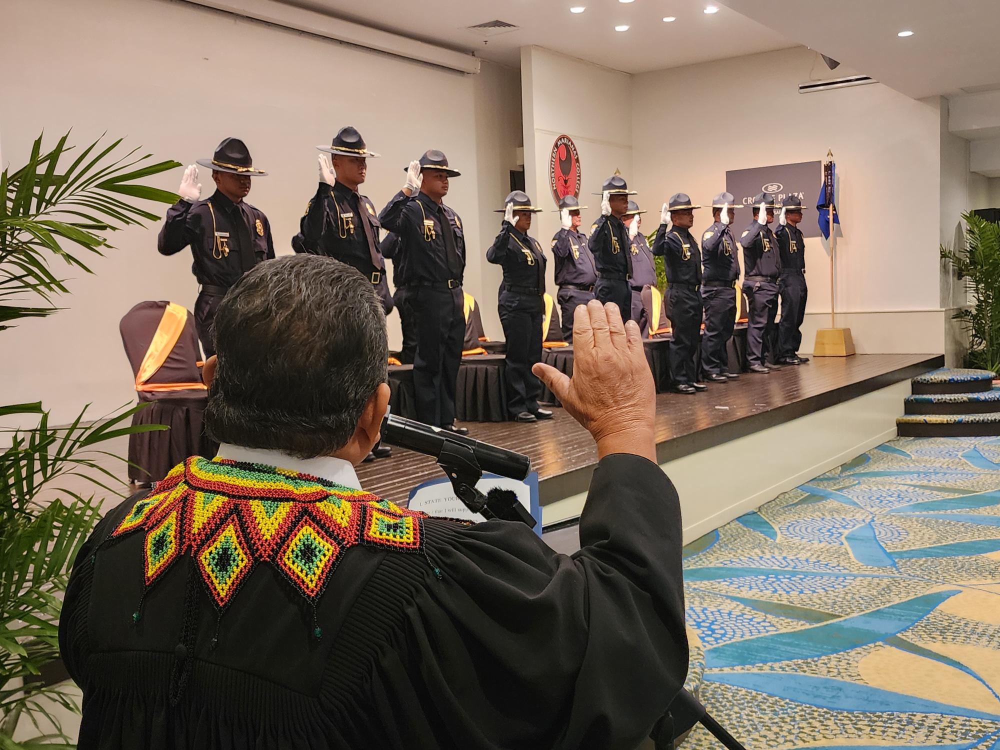 Chief Justice Alexandro Castro swears in the new Customs officers.