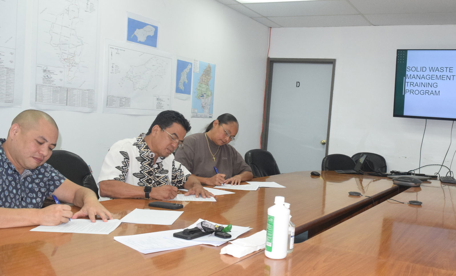 From left, Office of Planning & Development Deputy Director Chris Sablan, Department of Public Works Secretary Ray N. Yumul, and Northern Marianas Technical Institute Chief Executive Officer Jodina C. Attao sign their respective copies of a memorandum of understanding in the DPW conference room on Wednesday.