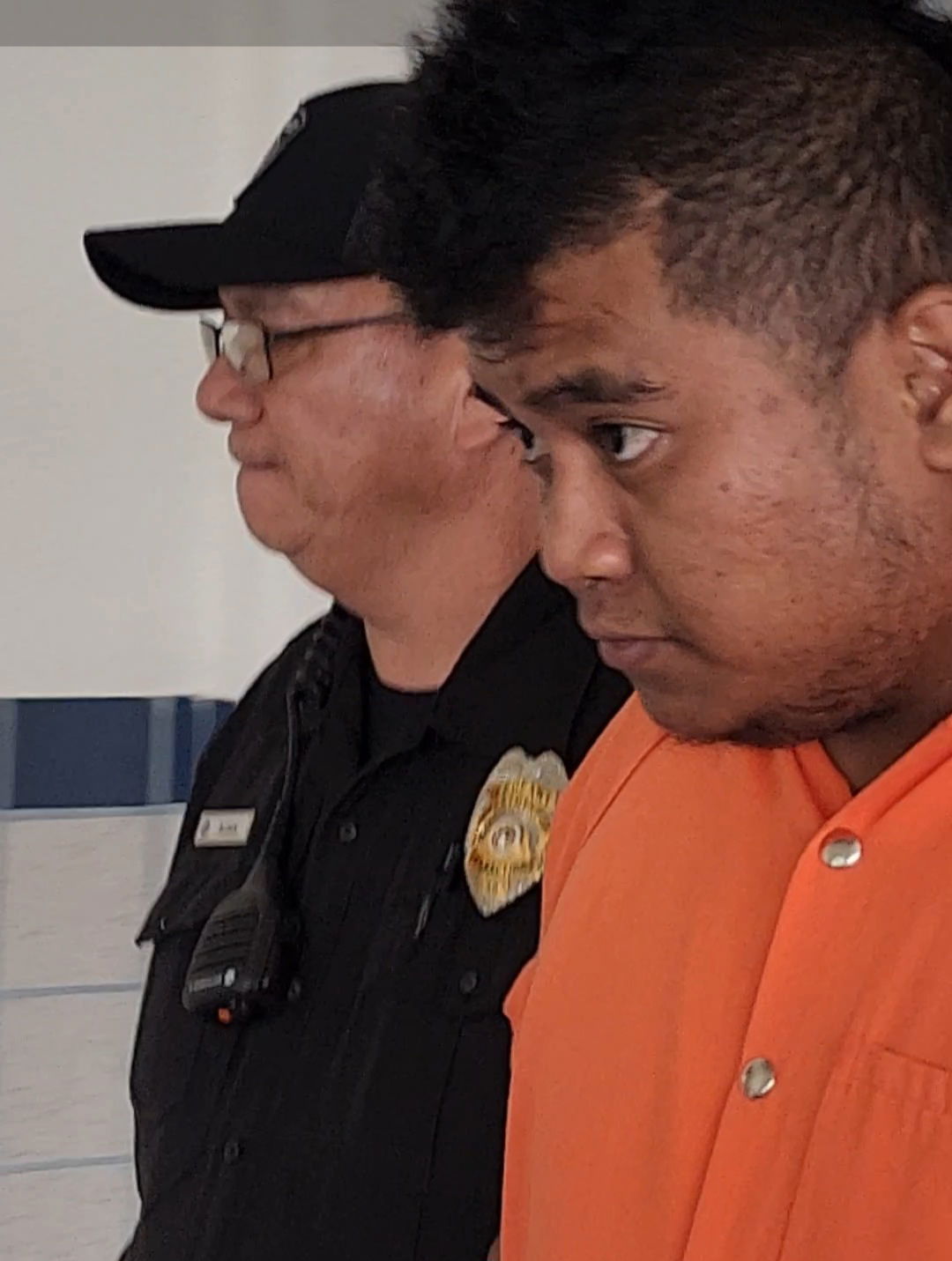 Berman Jr. Padock Higgins, right, is escorted by a Corrections officer to a courtroom for a bail hearing on Monday.