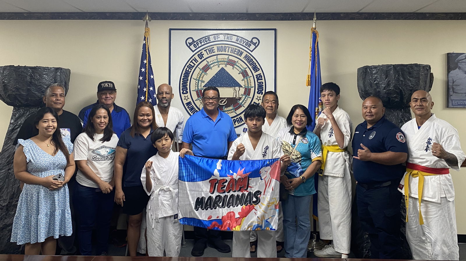 Saipan Mayor RB Camacho, center, and Sensei Danny Banez, right of center, pose for a photo with members of the CNMI Martial Arts Academy of Self-Defense-Kyokushinkai Karate Watanabe Dojo in the conference room of the mayor's office on Aug. 2, 2024. 