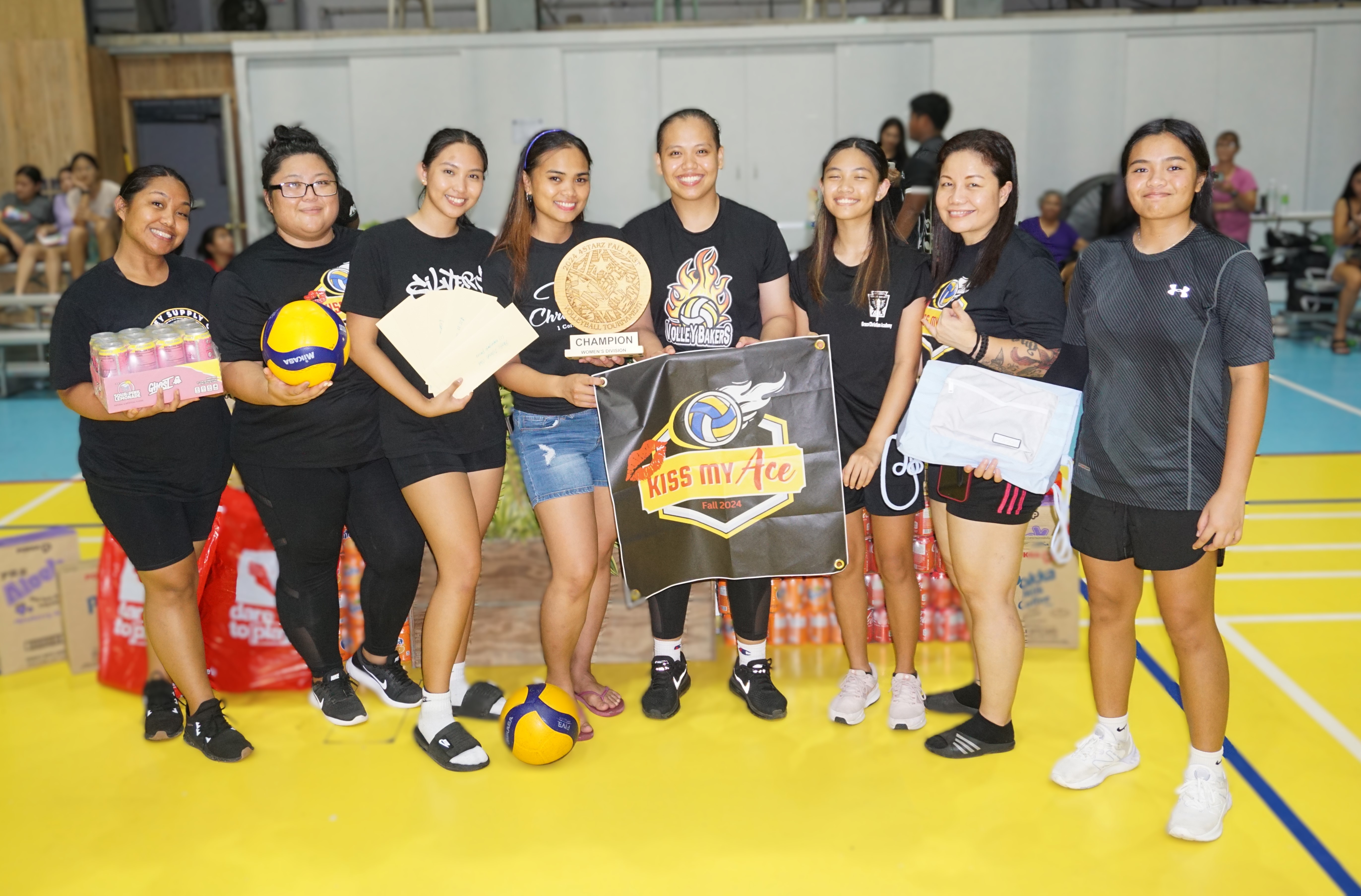 Kiss My Ace team members pose with the women’s division championship trophy and other prizes after winning the Fall Fest Volleyball Tournament 2024 at the Agape Gymnasium on Saturday.