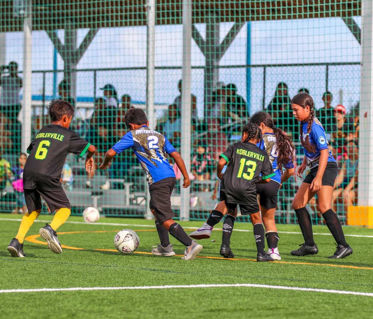 Garapan Elementary School's Joven Sablan defends the ball against Koblerville Elementary School's Arthur Basto and Ina Mettao in an elementary coed division game of the NMI Football Association's Inter-Scholastic Soccer League at the NMI Soccer Training Center in Koblerville on Wednesday.