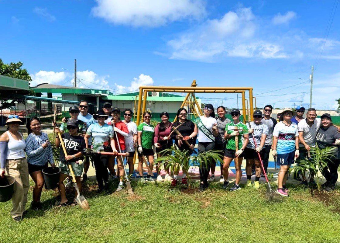 Latte FC women’s players, coaches and club officials join KoES Vice Principal Jonas Barcinas for a group photo after planting palm trees and santan plants at the school’s playground.