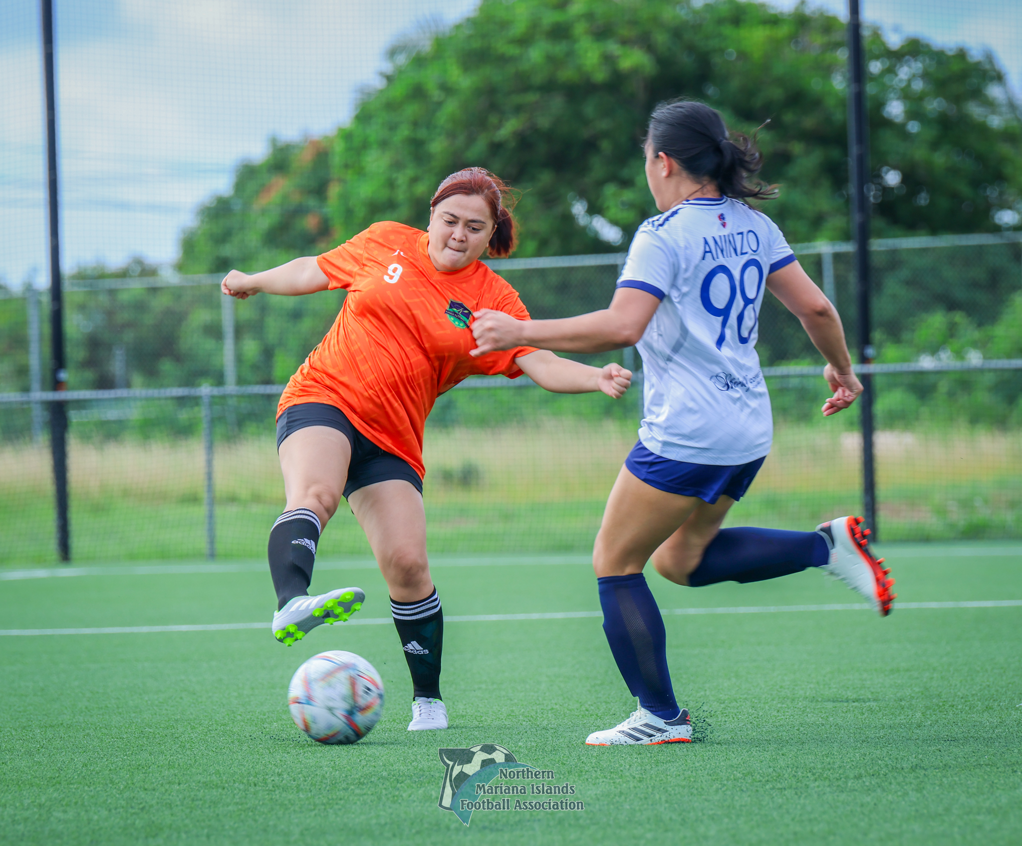 Kanoa FC’s Jean Bernardo defends the ball from Shirley's Christine Aninzo in a Division B game of the Dove Women’s League at the NMI Soccer Training Center in Koblerville on Sunday.