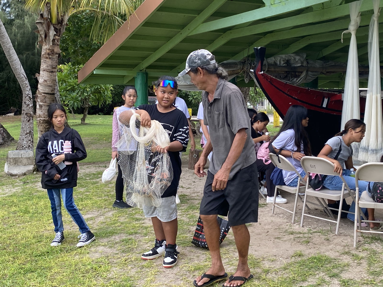 Students participate in cultural activities as part of the Cultural Roadmap program. This young man is learning to throw a talaya.