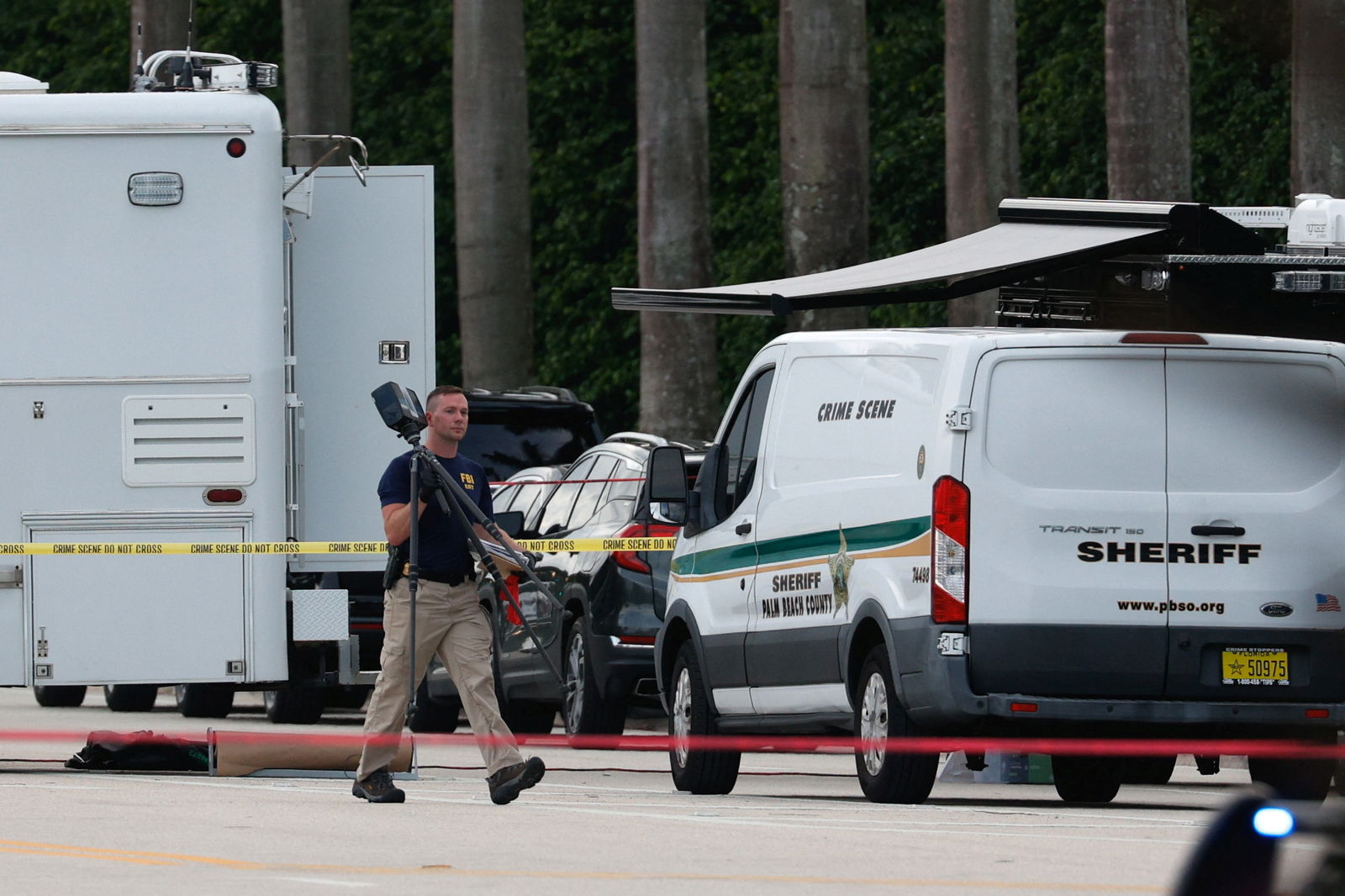 A law enforcement officer walks after reports of shots fired outside Republican presidential nominee and former President Donald Trump's Trump International Golf Course in West Palm Beach, Florida, Sept. 15, 2024.