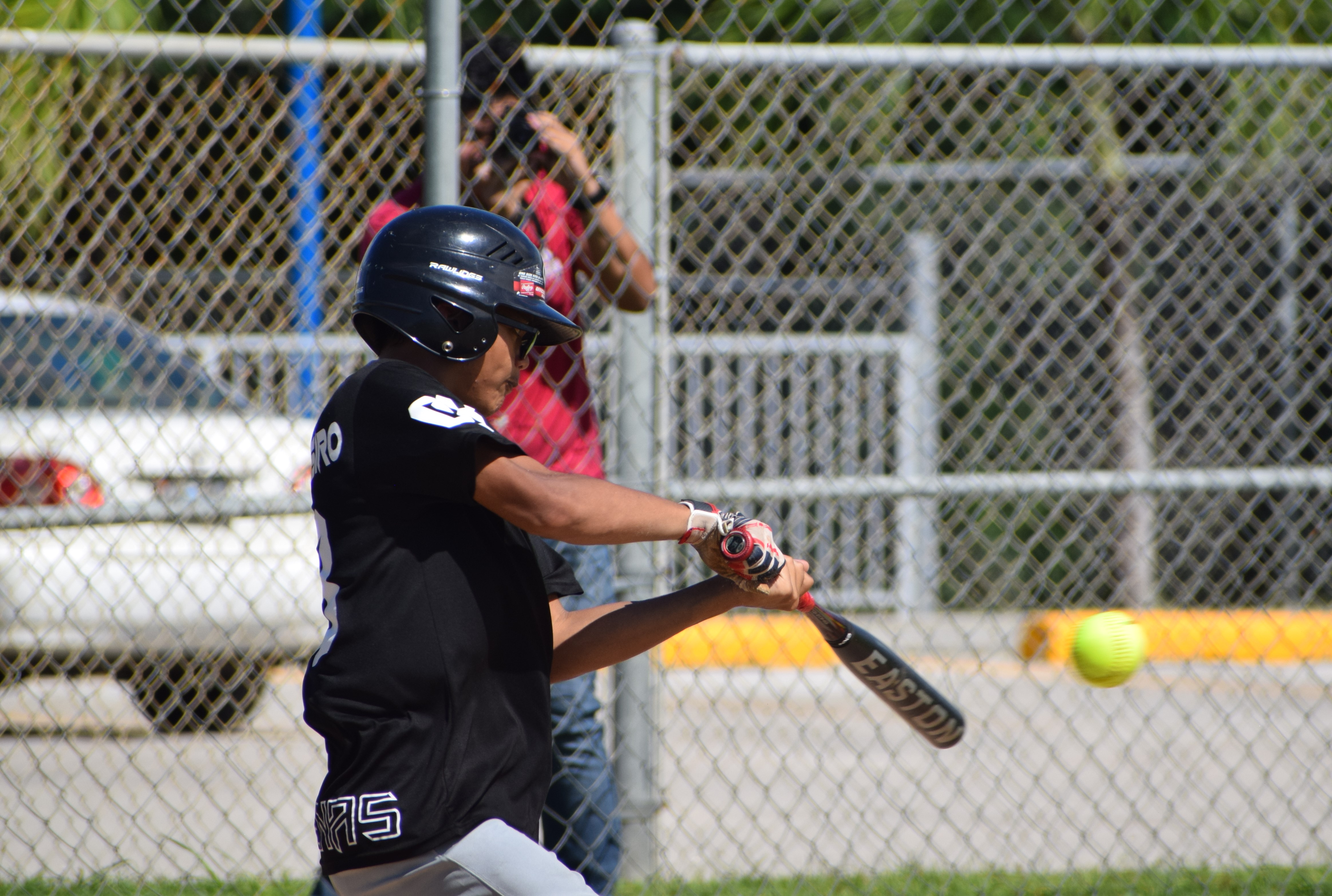 Mount Carmel Knights' Brandon Tesiro hits the ball during a PSS Boys Fastpitch Softball regular season game at Dandan Middle School Ballfield on Saturday.