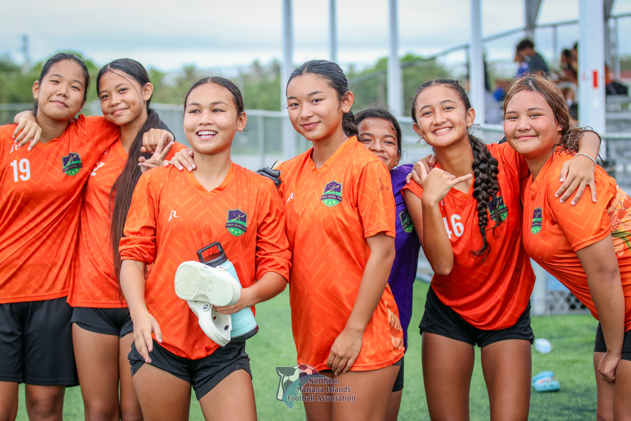 Saipan International School's Beatrice Gross, 2nd right, poses for a photo with teammates after playing a match at the NMI Soccer Training Center in Koblerville.