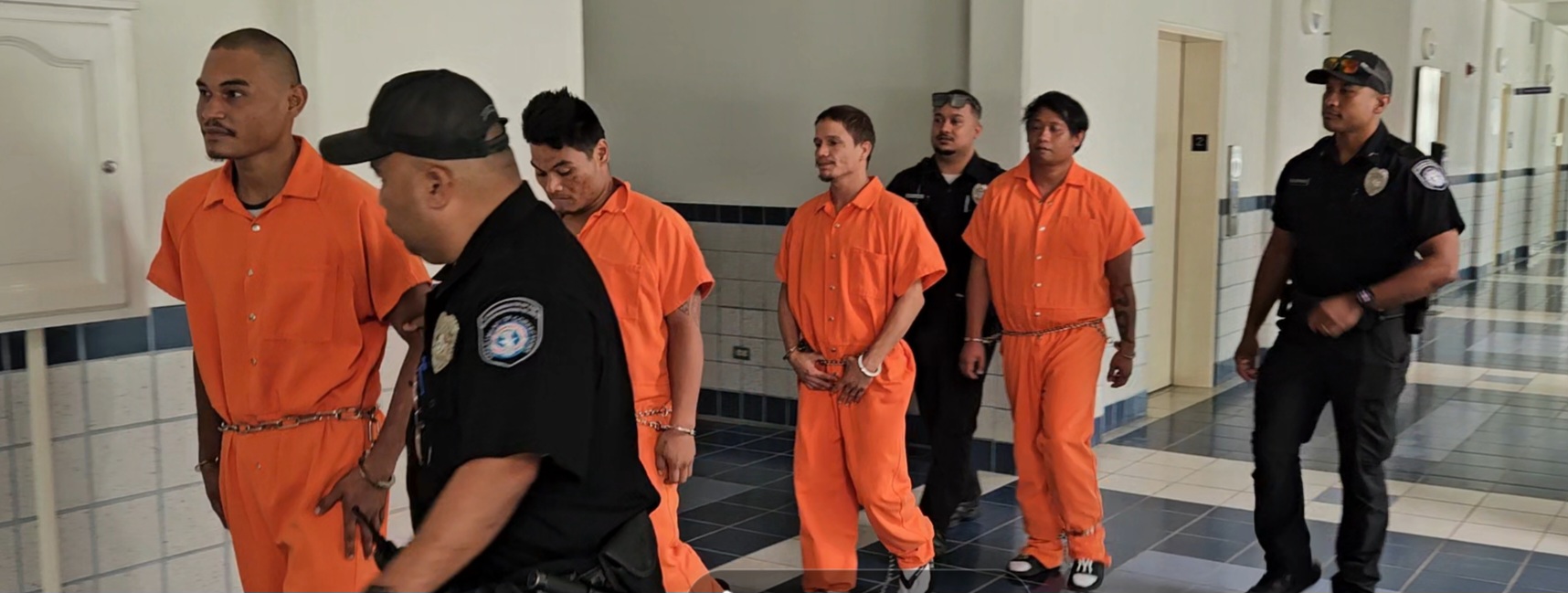 From left, Venny Babauta Untalan, 27, Dino Mettao, 33, George Grover, 33, and Jimmy Joaquin Jr., 34, are escorted by Corrections officers to a courtroom for a bail hearing on Monday morning. 