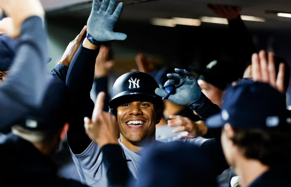 New York Yankees right fielder Juan Soto (22) celebrates with teammates in the dugout after hitting a two-run home run against the Seattle Mariners during the fourth inning at T-Mobile Park in Seattle, Washington, Sept. 17, 2024.