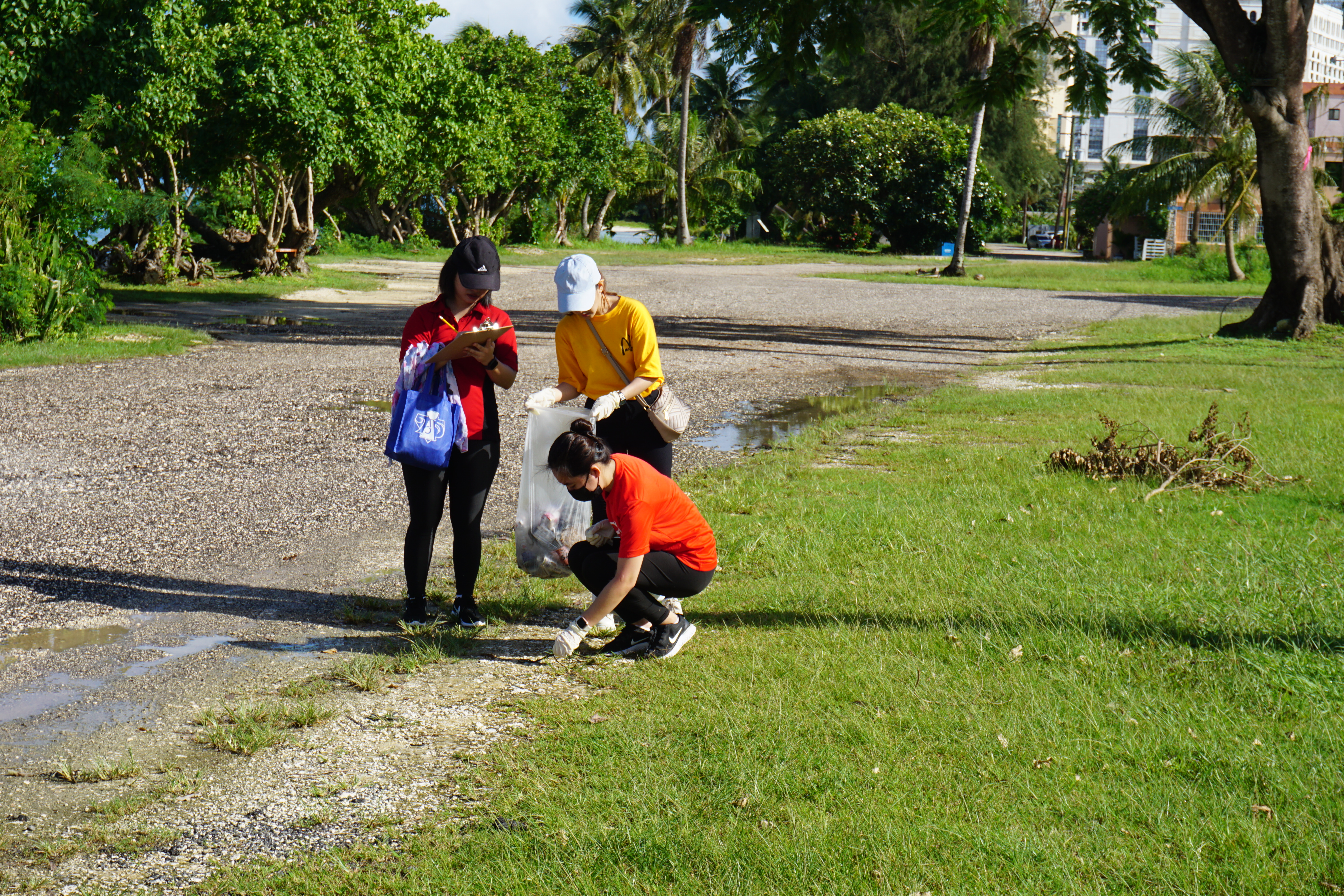 Island residents at Makaka Beach take note of the litter they found there on Saturday. 