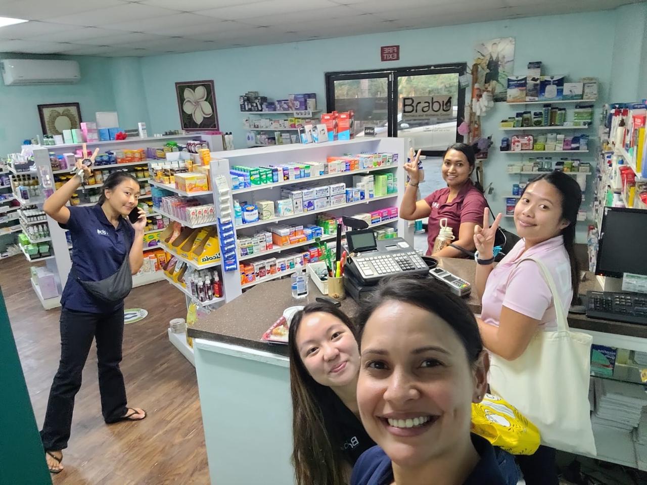 Employees of Brabu Pharmacy and Wellness Center at the Gualo Rai branch mug for the camera.