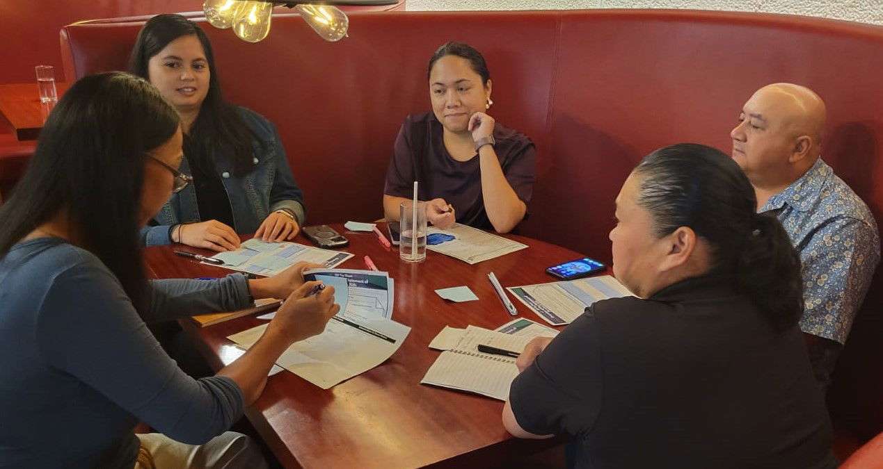 Commissioner of Education Dr. Lawrence F. Camacho, right, and a group of stakeholders and advocates discuss Project Higai’s online special education course activities.