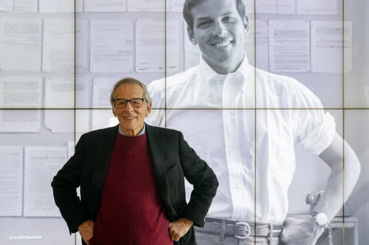 Author and biographer Robert Caro stands beside an image of his younger self after touring a permanent exhibit in his honor at the New York Historical Society Museum & Library in New York on Oct. 20, 2021.