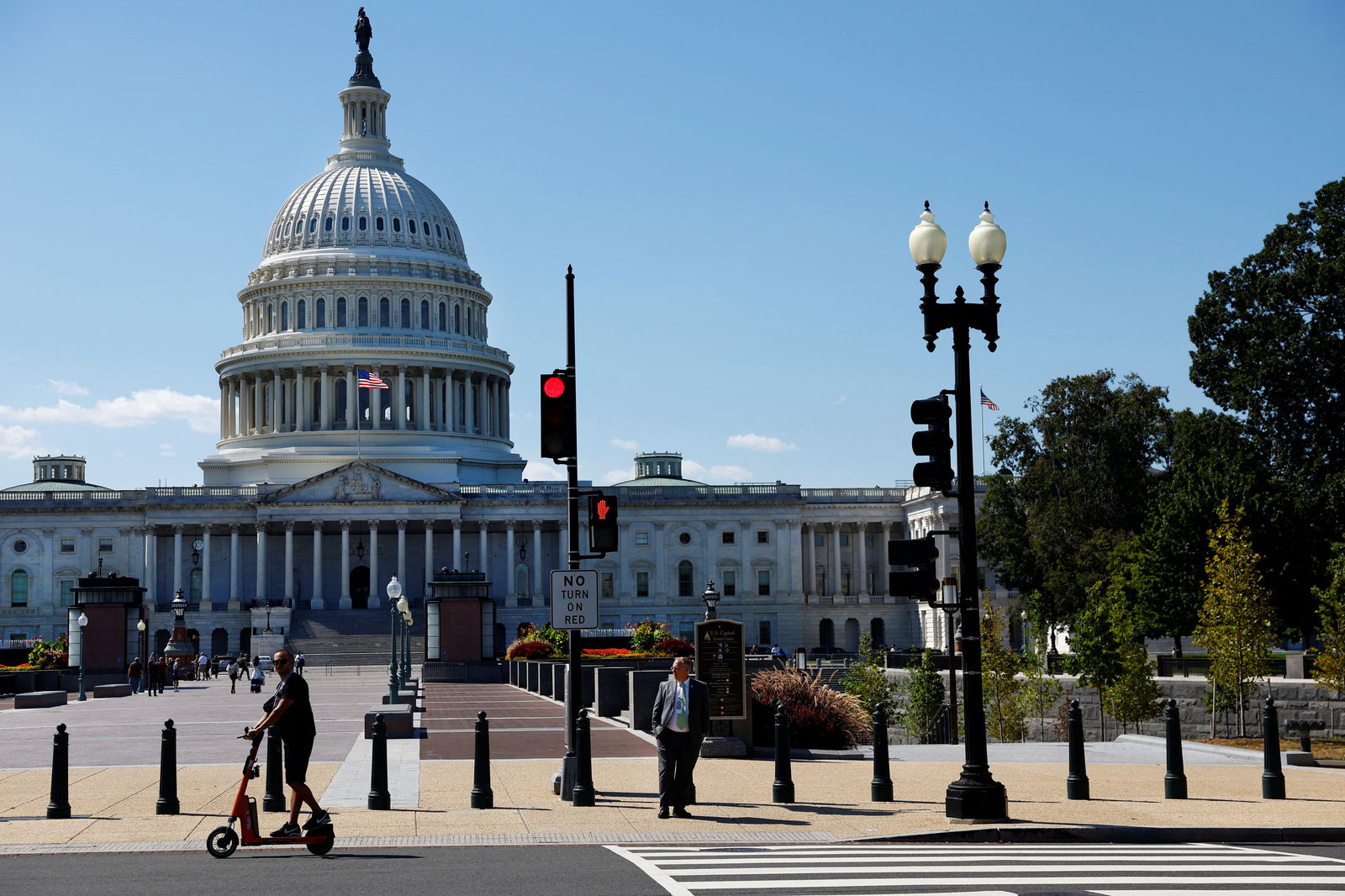 A man passes by the U.S. Capitol on his scooter in Washington, D.C., Sept. 10, 2024.
