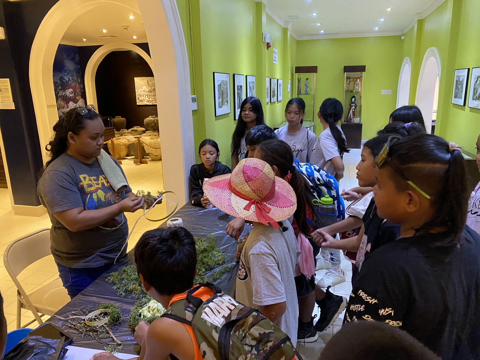 Students learn how to make a mwar at the NMI Museum of History and Culture.