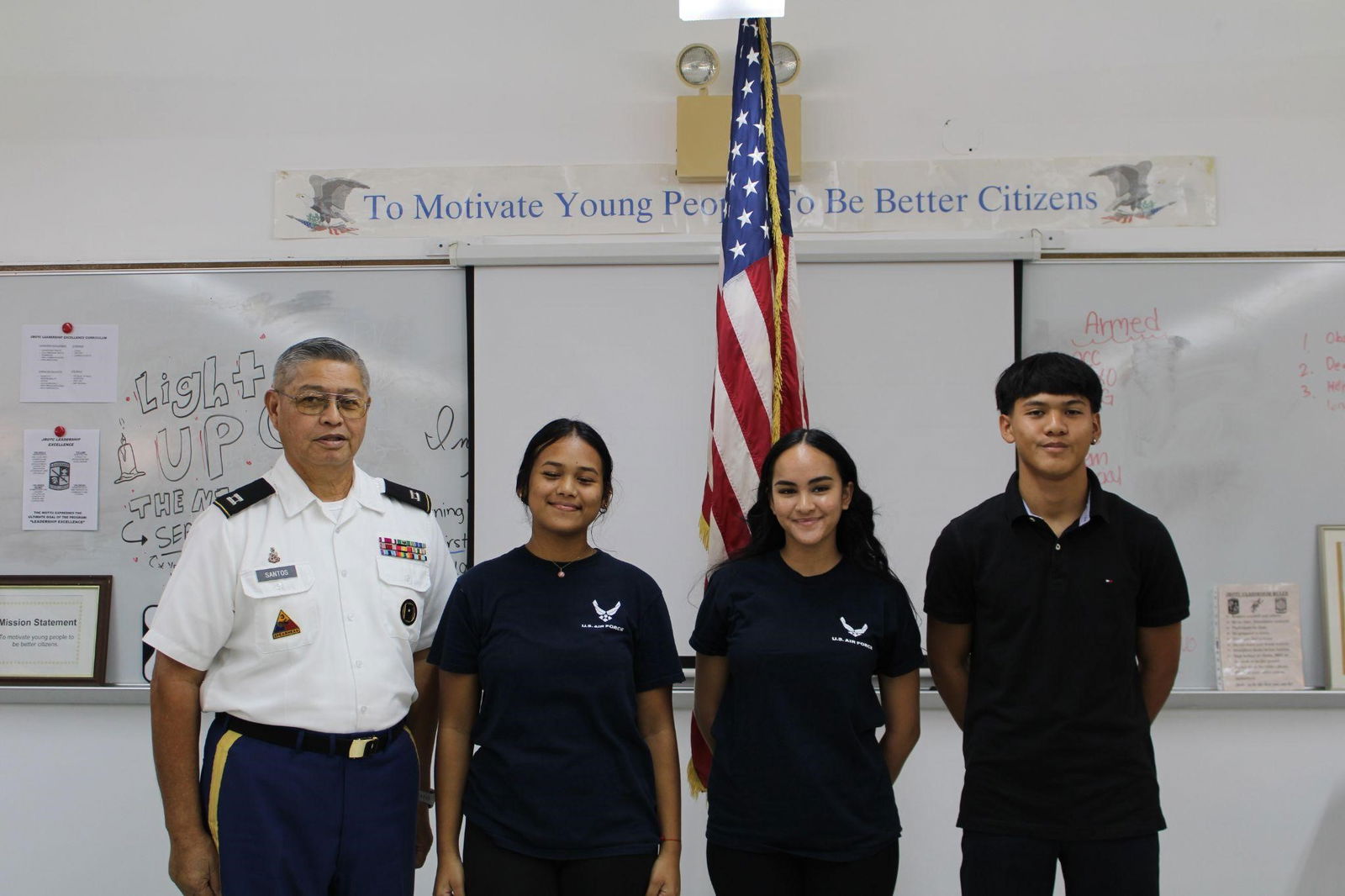 Gus Palacios, Journey Dela Cruz Reyes and Kiwalani Cabrera pose for a photo with Captain Santos.
