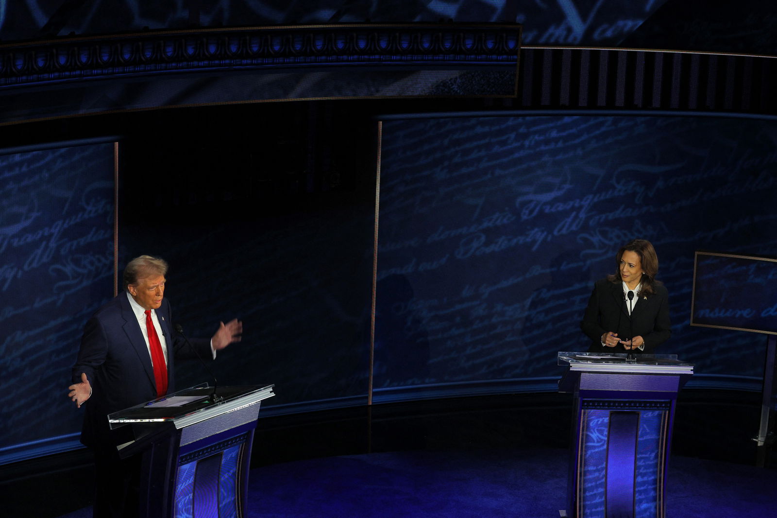 Republican presidential nominee Donald Trump speaks as his Democratic opponent Kamala Harris listens during a presidential debate hosted by ABC in Philadelphia, Pennsylvania, Sept. 10, 2024.