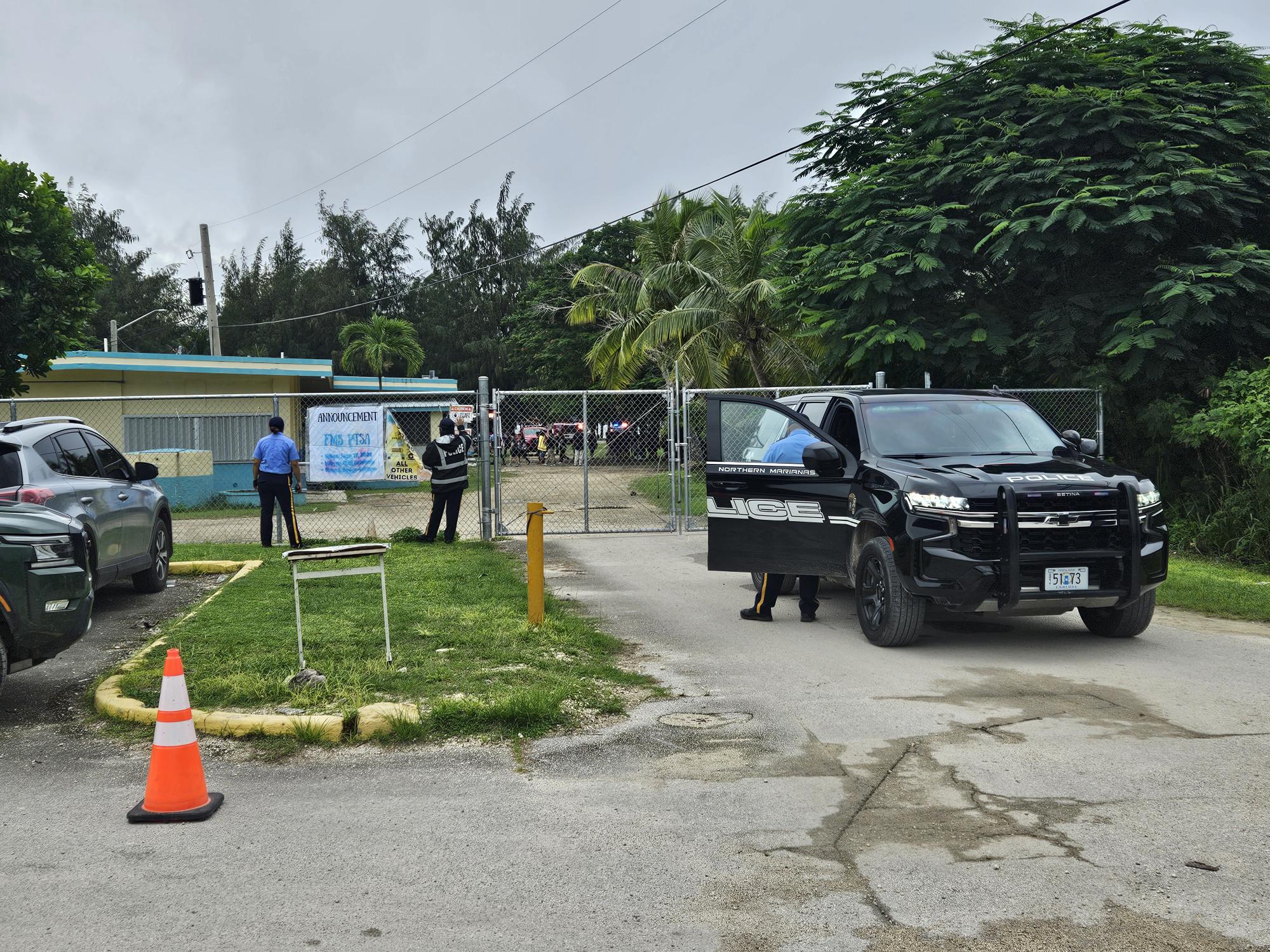 Department of Public Safety first responders are seen one of the entrances to Francisco M. Sablan Middle School Friday morning after the campus went into lockdown