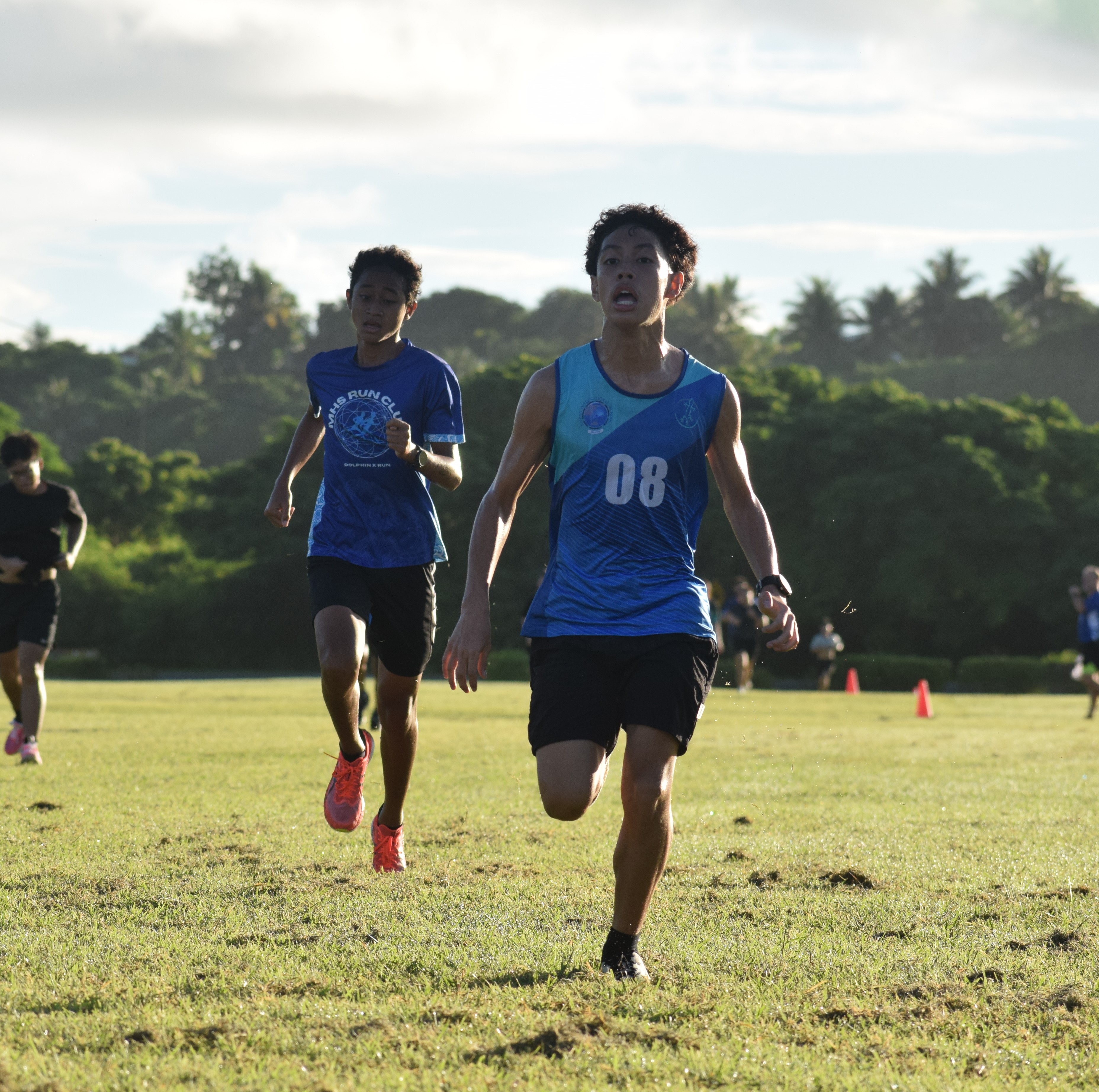 Saipan International School's Nash Santos and Marianas High School's Jim Takeru head to the finish line in the high school boys division.