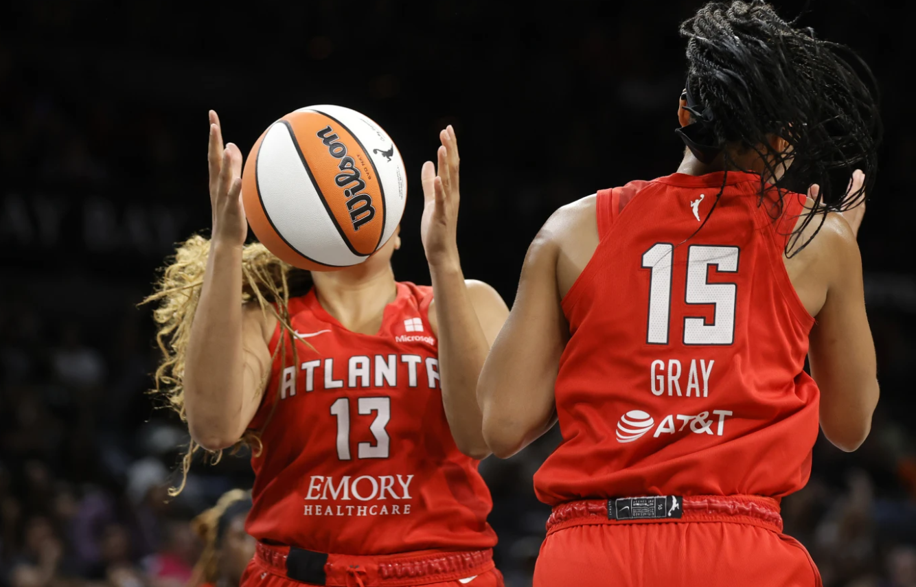 Atlanta Dream guard Haley Jones (13) makes a rebound by teammate Alisha Gray (15) during a WNBA game against the Las Vegas Aces on Aug. 30, 2024 in Las Vegas.