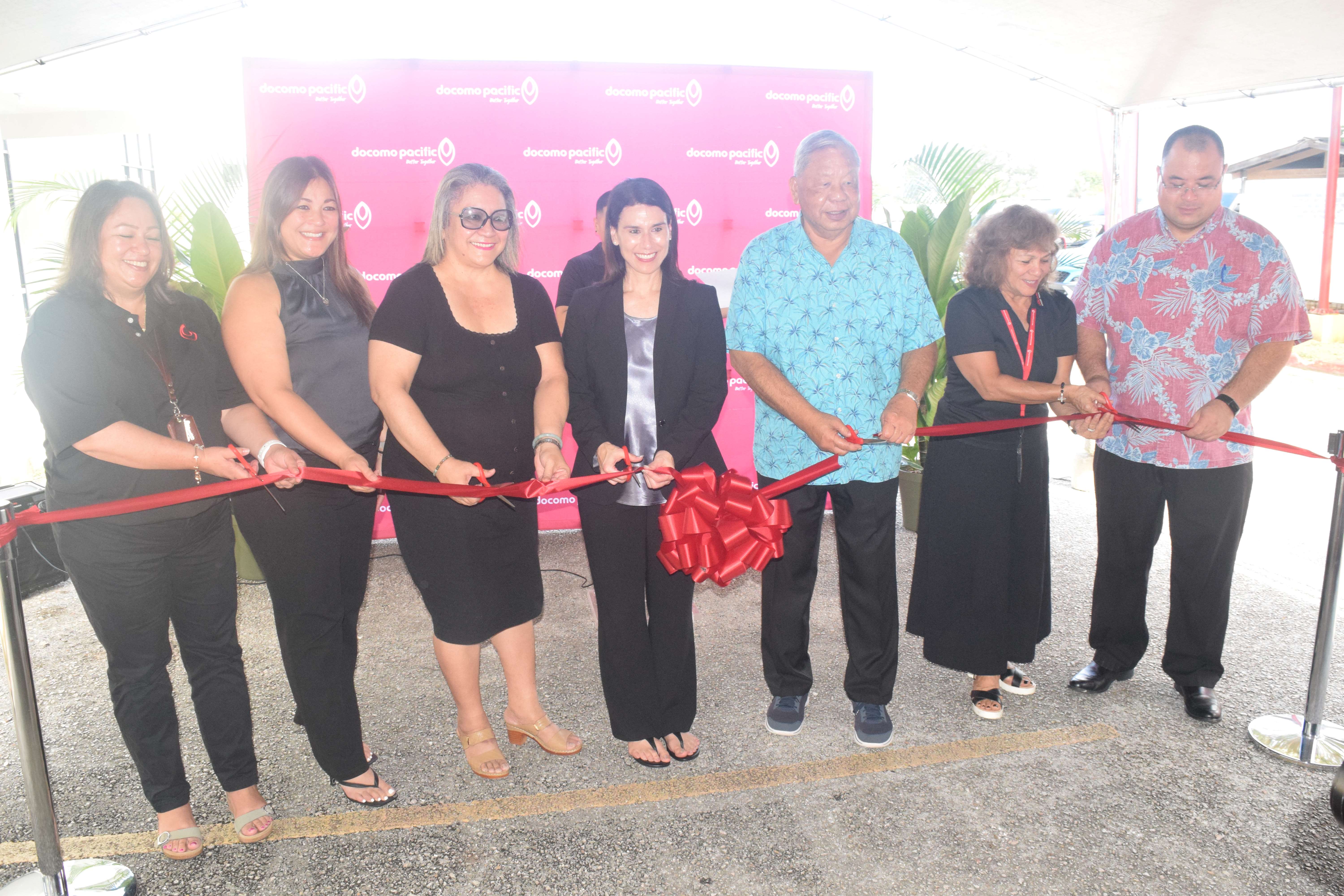 Lt. Gov. David M. Apatang, third right, Senate President Edith Deleon Guerrero, third left, and Speaker Edmund S. Villagomez, right, join Docomo Pacific President and Chief Executive Officer Christine Baleto, center, and other Docomo officials in a ribbon-cutting ceremony at Docomo Pacific in Gualo Rai on Wednesday.