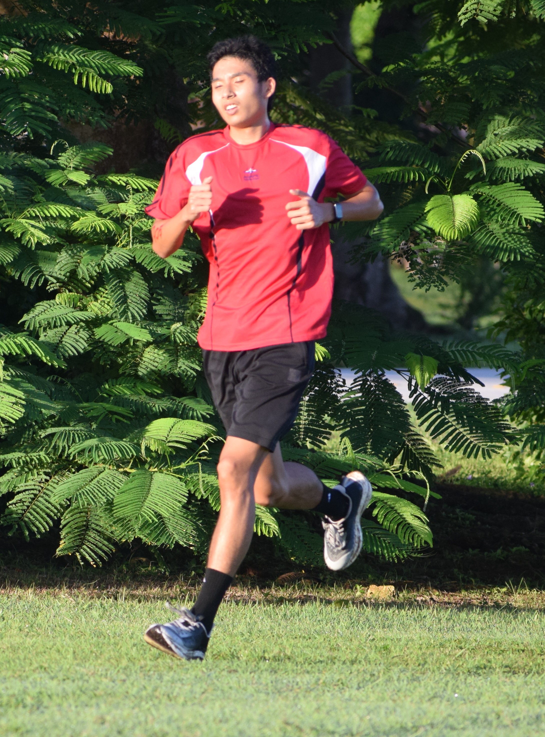 Agape Christian School's Jireh Wang takes the lead in the first lap of the three-mile race for high school boys.