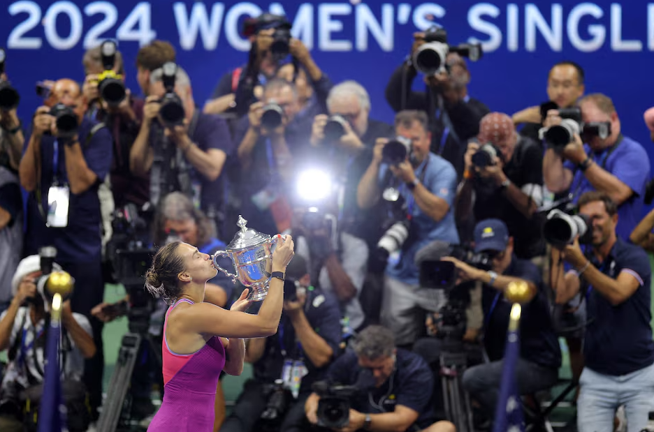 Aryna Sabalenka kisses her U.S. Open trophy after beating Jessica Pegula in Flushing Meadows, New York, Sept. 7, 2024.