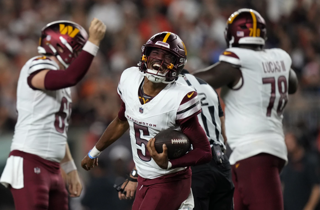 Washington Commanders quarterback Jayden Daniels (5) celebrates after throwing a touchdown pass during the second half of an NFL game against the Cincinnati Bengals, Monday, Sept. 23, 2024 in Cincinnati.