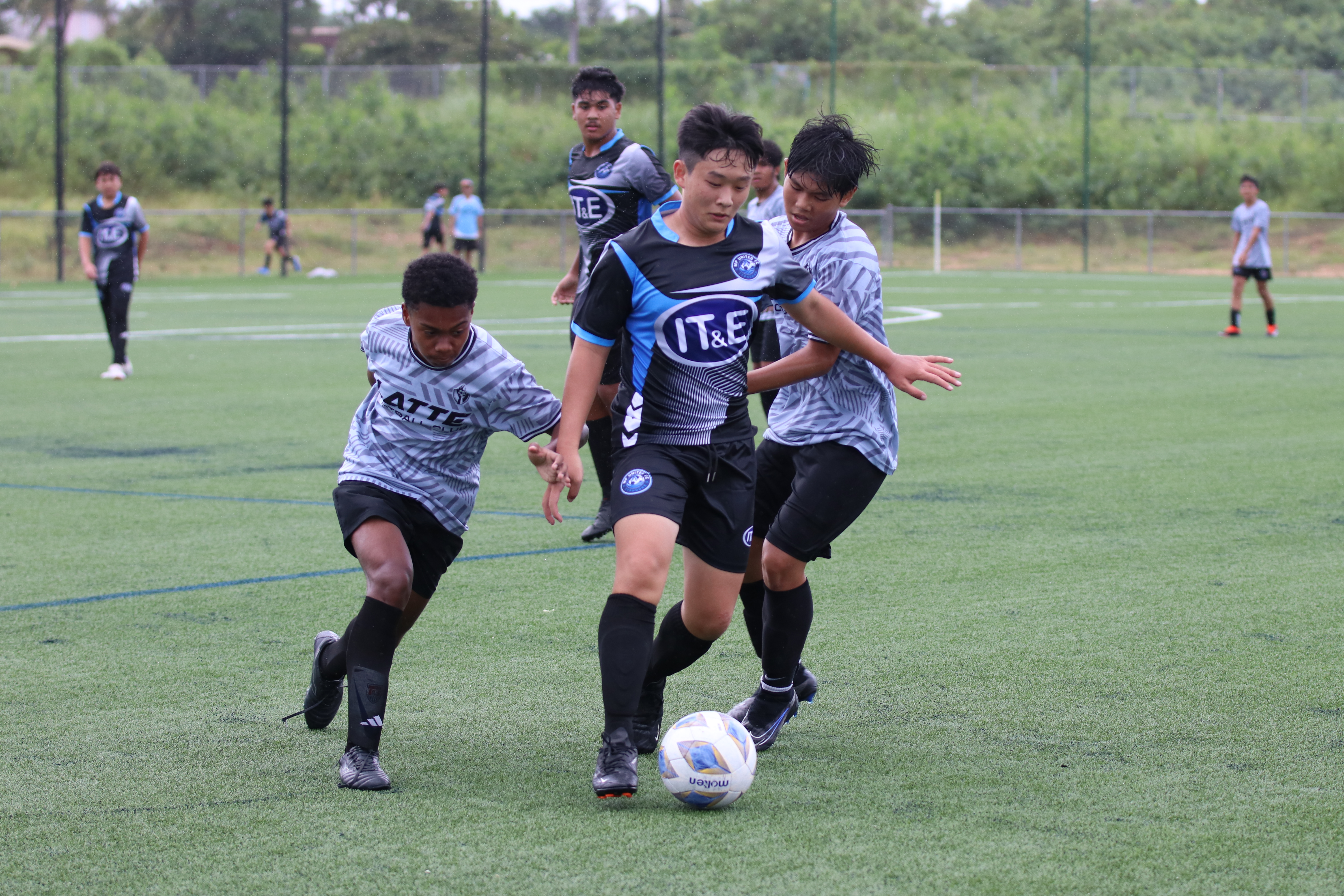 An MP United player keeps the ball safe from Latte MP defenders during a U14 Boys Division game of the TakeCare Youth Soccer League Fall 2024 tournament at the NMI Soccer Training Center in Koblerville on Saturday.
