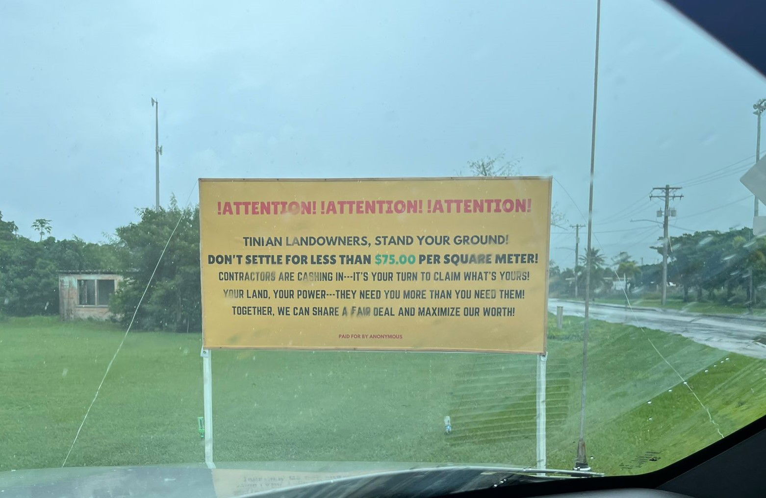 A group of anonymous individuals erected this signboard next to the Tinian baseball field, urging landowners not to settle for less for their properties.