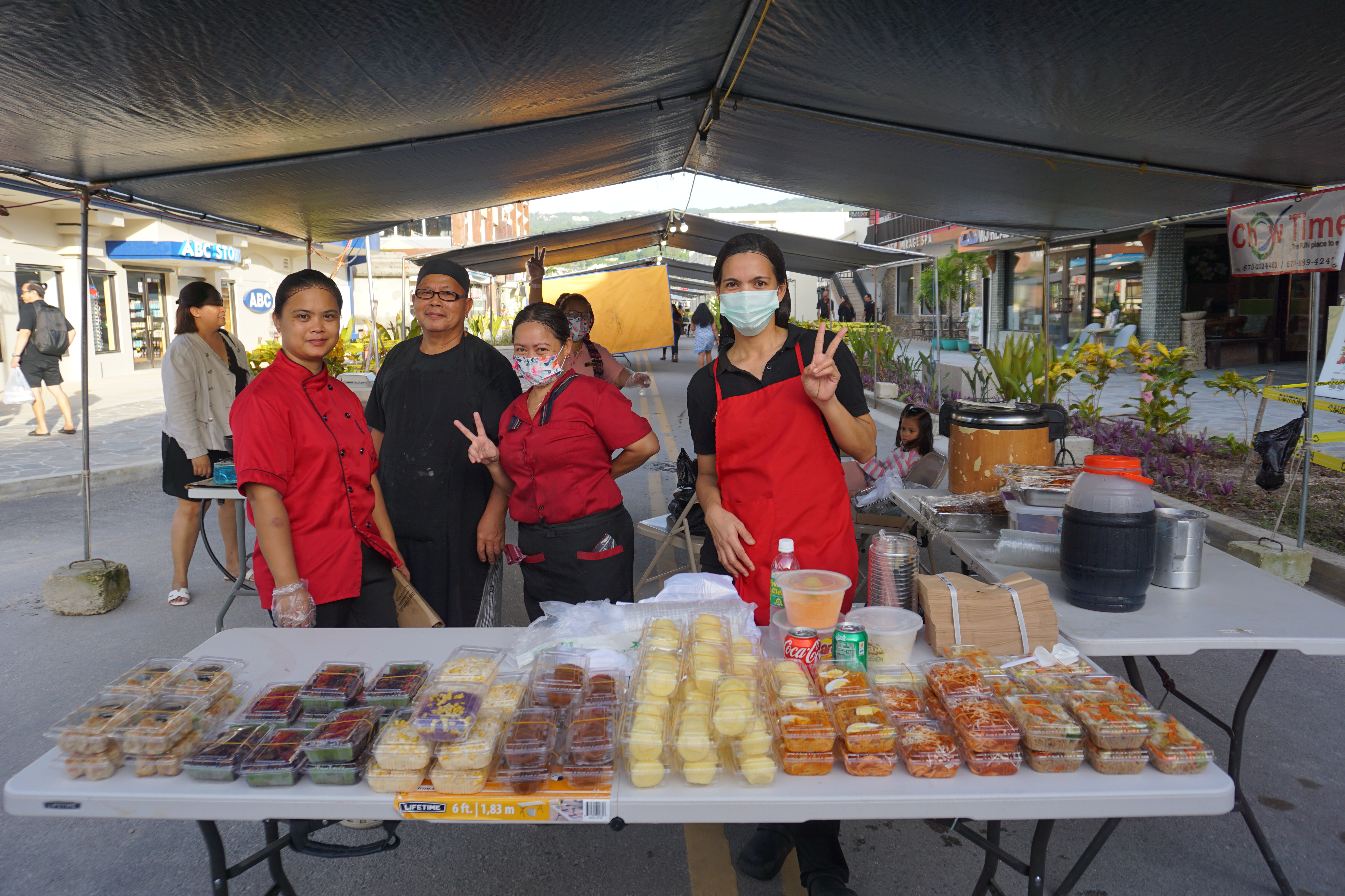 Chowtime staff pose for a photo with some of the food they are selling.
