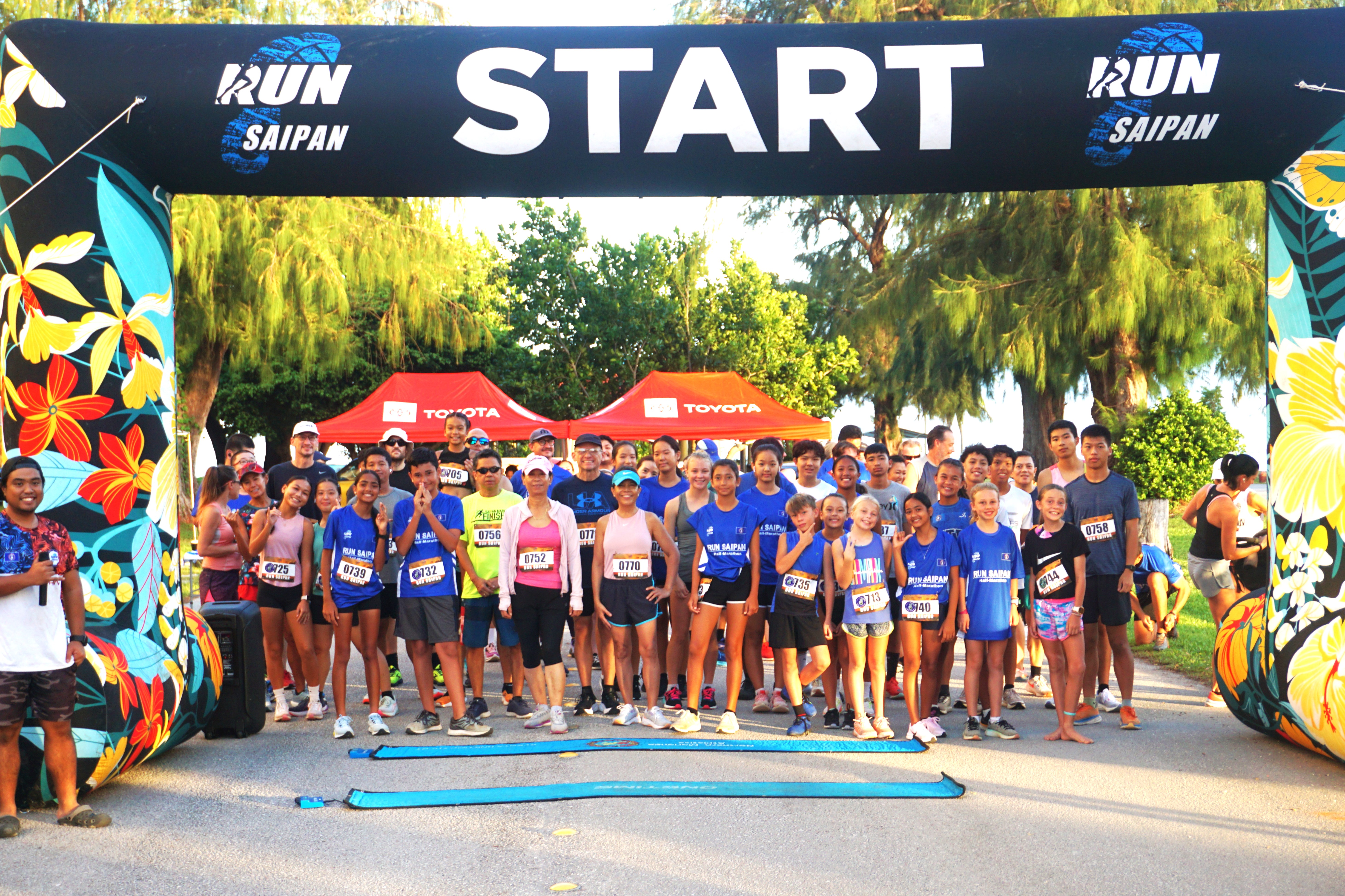 Participants of the 5K Fun Run pose for a photo before the start of the race at American Memorial Park on Saturday. 