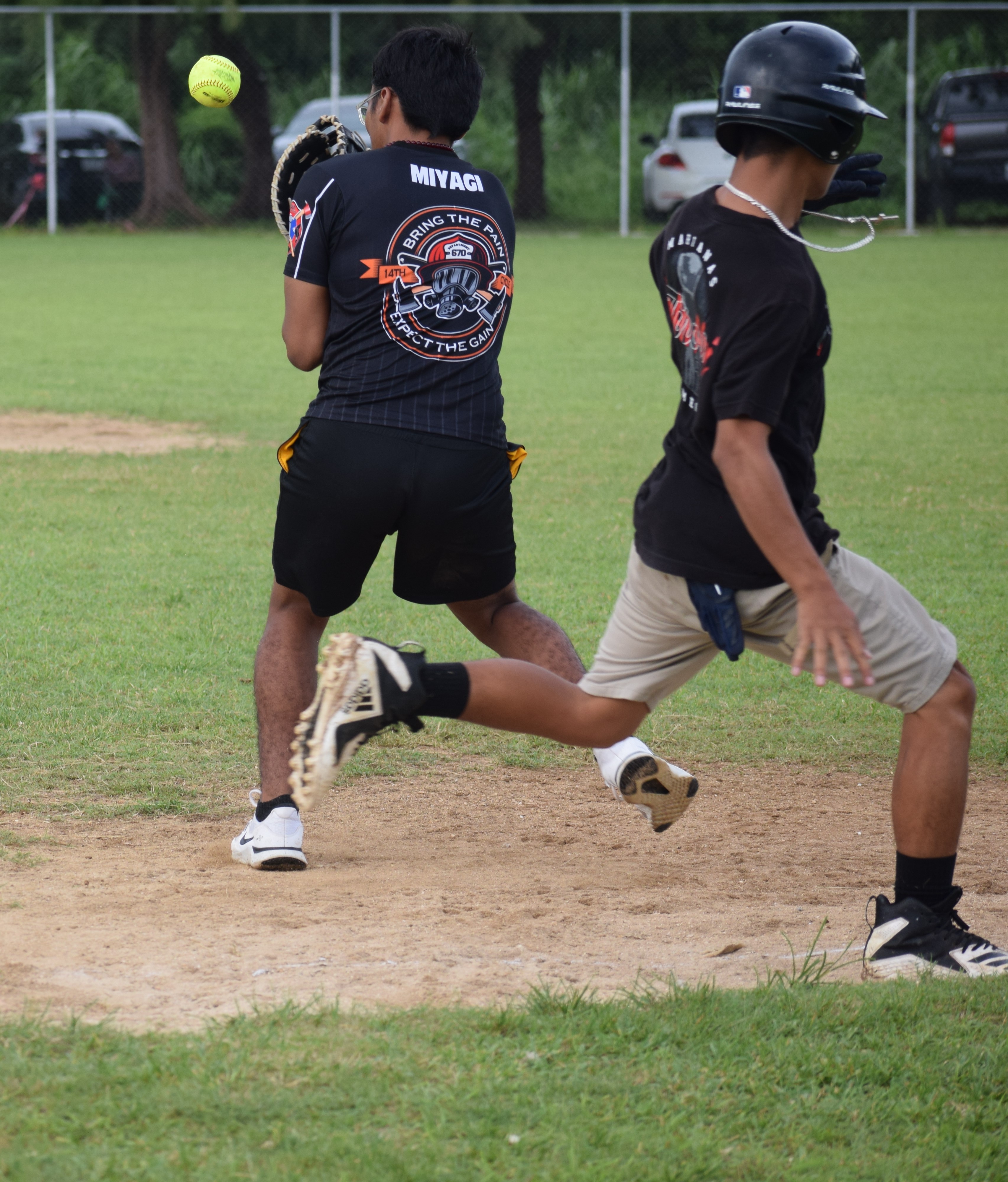 A Marianas High School base runner makes it to the first base as Kagman High School’s first baseman loses the ball.