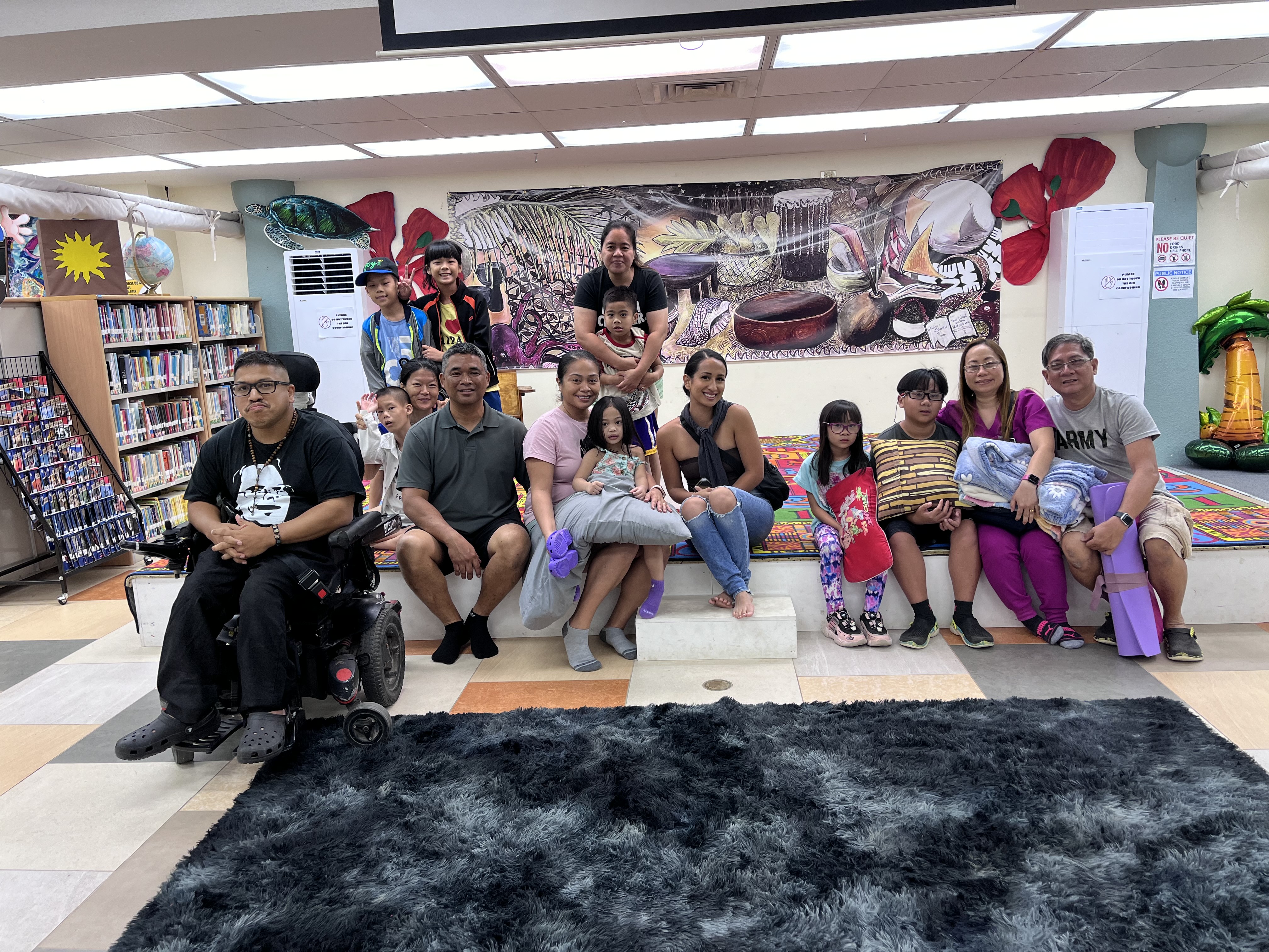 Asia Camacho Hilario, center, poses with some of the participants of a sound bath healing session she conducted at Joeten-Kiyu Public Library.