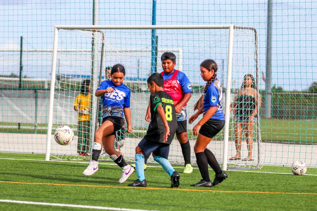 Garapan Elementary School's Cherise Rangamar kicks the ball away from Koblerville Elementary School's Jun Mullens.