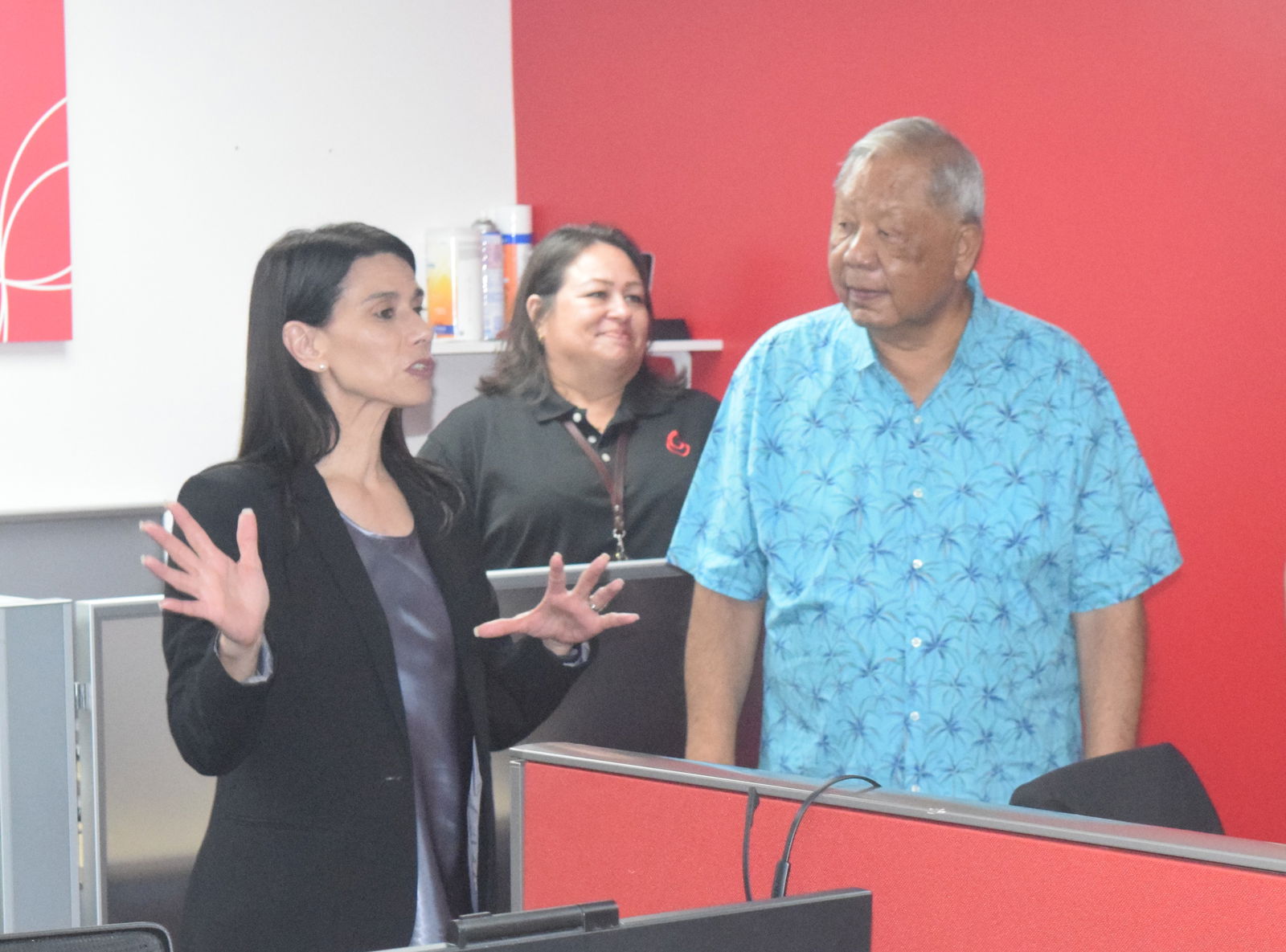 Docomo Pacific President and Chief Executive Officer Christine Baleto speaks as Lt. Gov. David M. Apatang and Docomo Pacific Consumer Sales Supervisor Verna Sablan listen during the opening of a new call center in Gualo Rai on Wednesday.