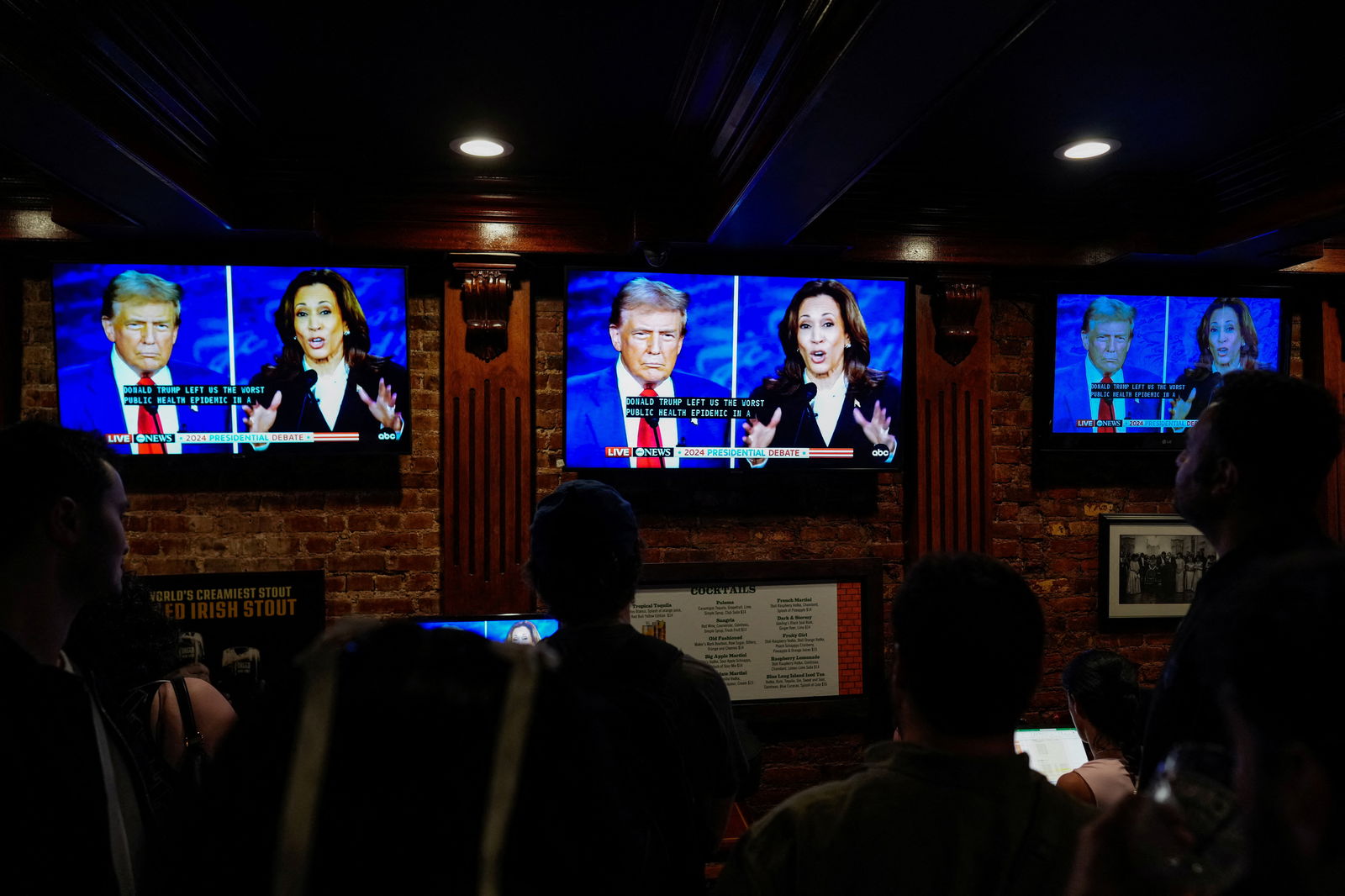 People watch the presidential debate between Republican presidential nominee Donald Trump and his Democratic opponent Kamala Harris at a watch party hosted by the New York Young Republican Club, in New York City, Sept. 10, 2024.