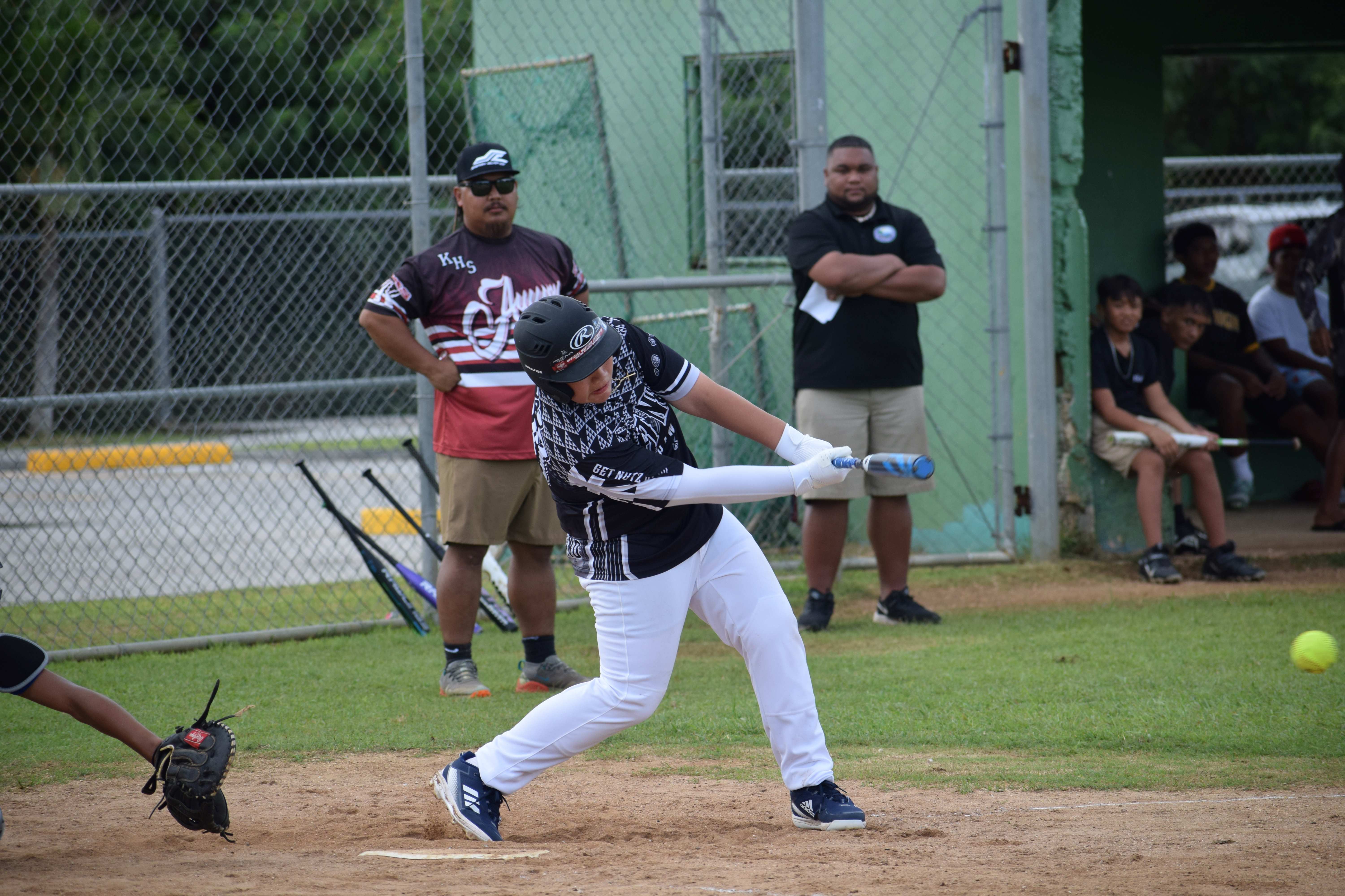 Marianas High School's Hunter Dela Cruz hits the ball.